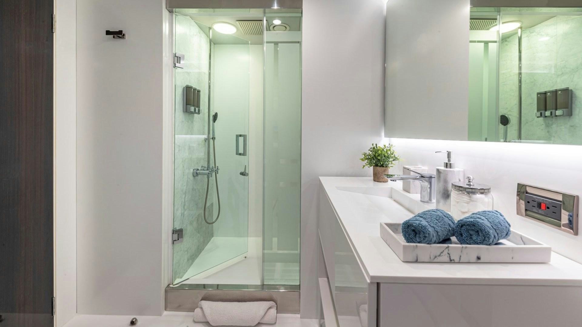 a bathroom with a glass shower aboard OCULUS Yacht for Sale