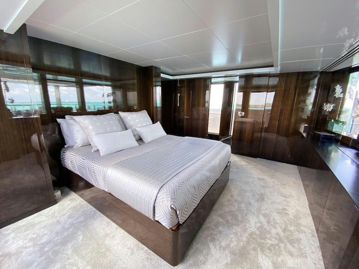 a large bedroom with a large bed aboard OCULUS Yacht for Sale