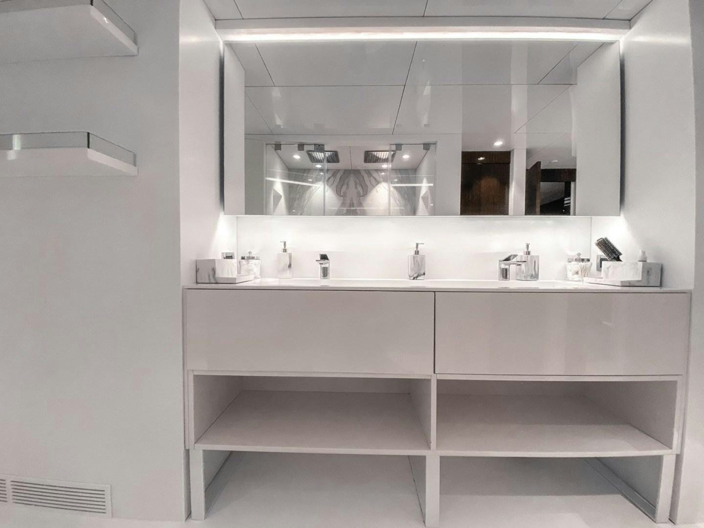 a white kitchen with white cabinets aboard OCULUS Yacht for Sale