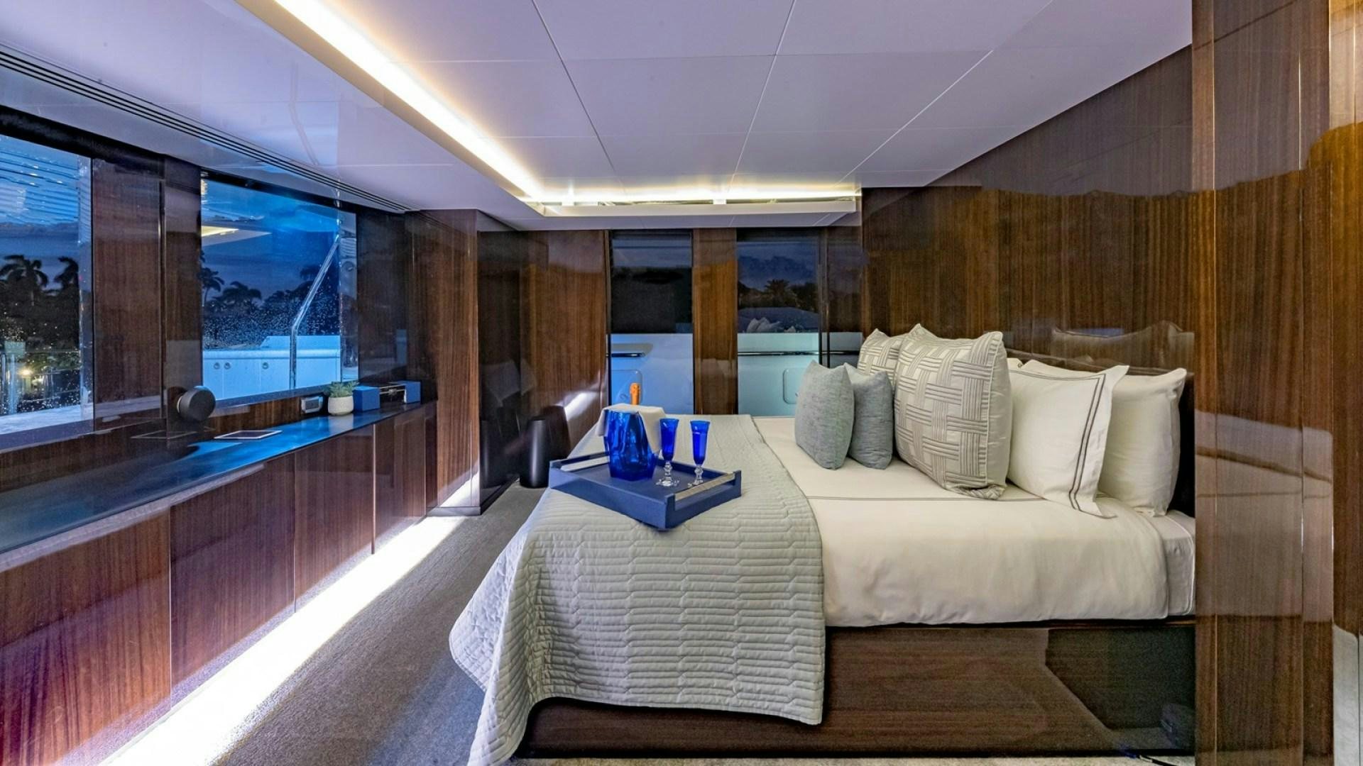 a room with a bed and a table aboard OCULUS Yacht for Sale