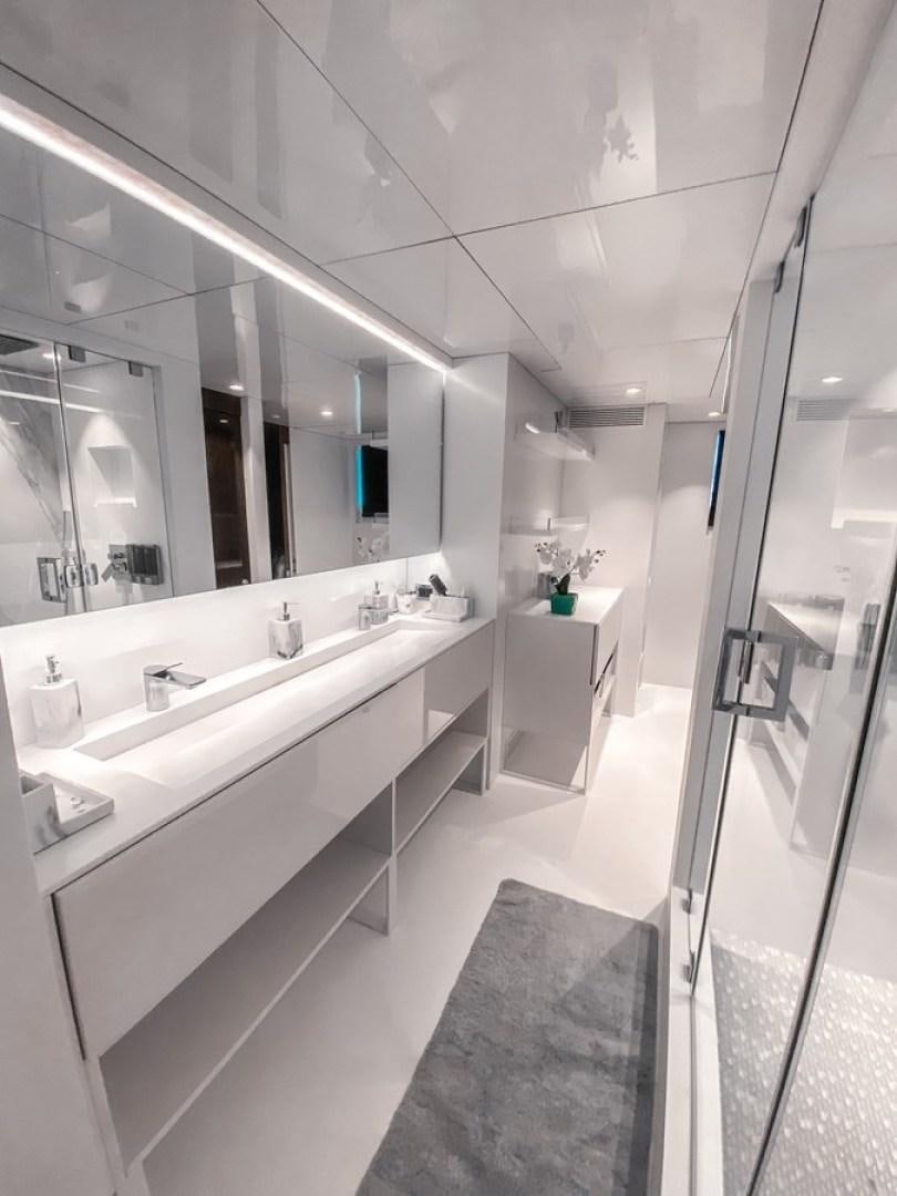 a bathroom with a large mirror aboard OCULUS Yacht for Sale