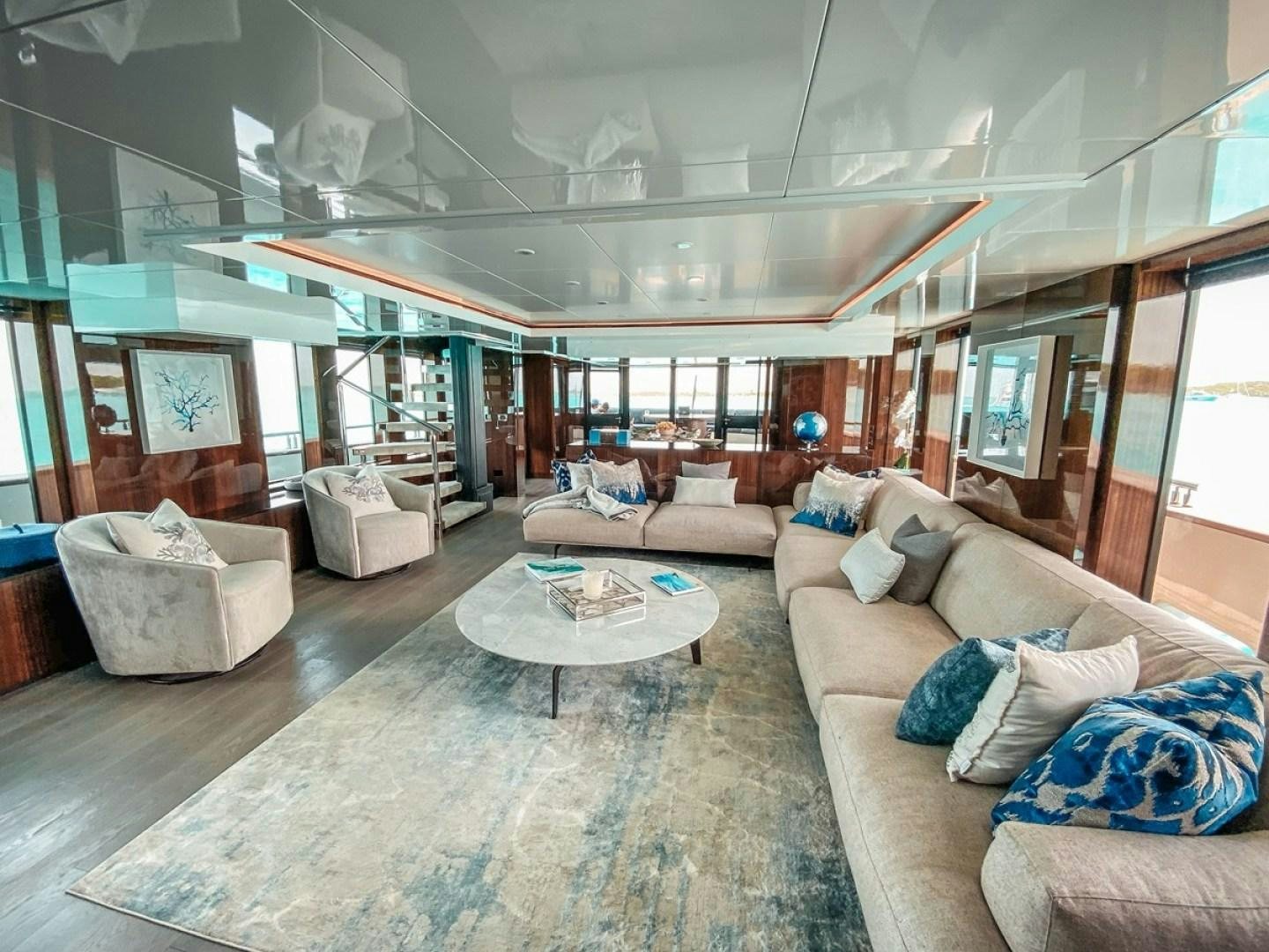 a living room with a large window aboard OCULUS Yacht for Sale