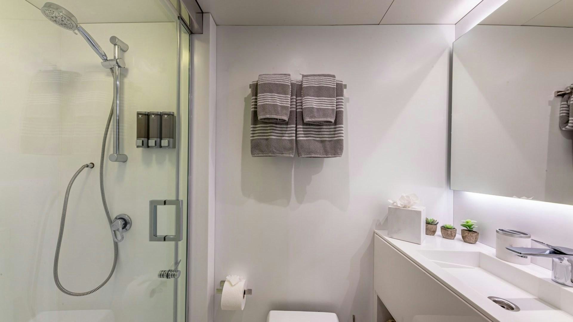 a bathroom with a shower and sink aboard OCULUS Yacht for Sale