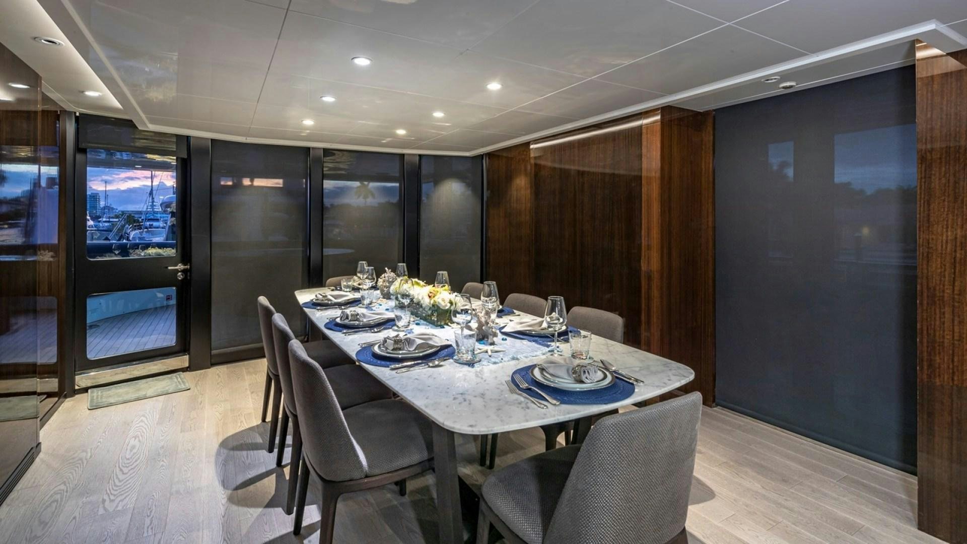 a dining room with a table and chairs aboard OCULUS Yacht for Sale
