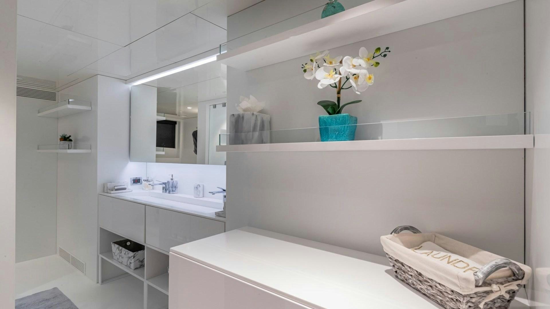 a bathroom with a large white counter aboard OCULUS Yacht for Sale