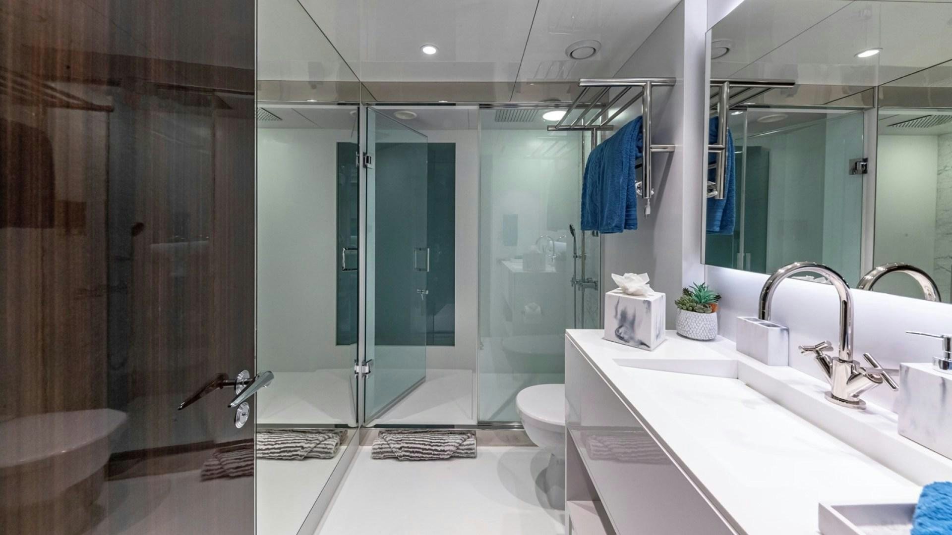 a bathroom with a glass shower aboard OCULUS Yacht for Sale