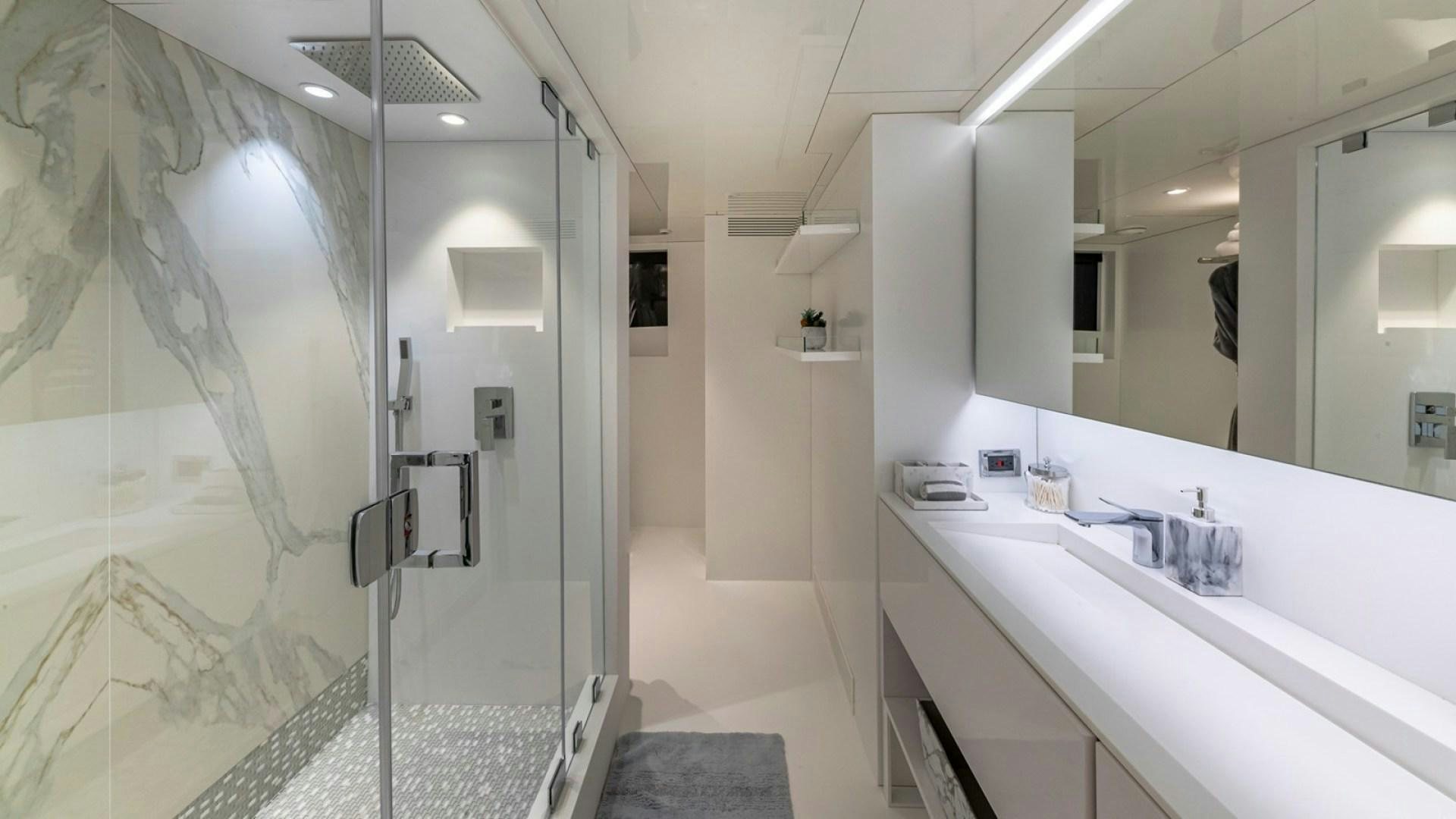 a bathroom with a glass shower aboard OCULUS Yacht for Sale