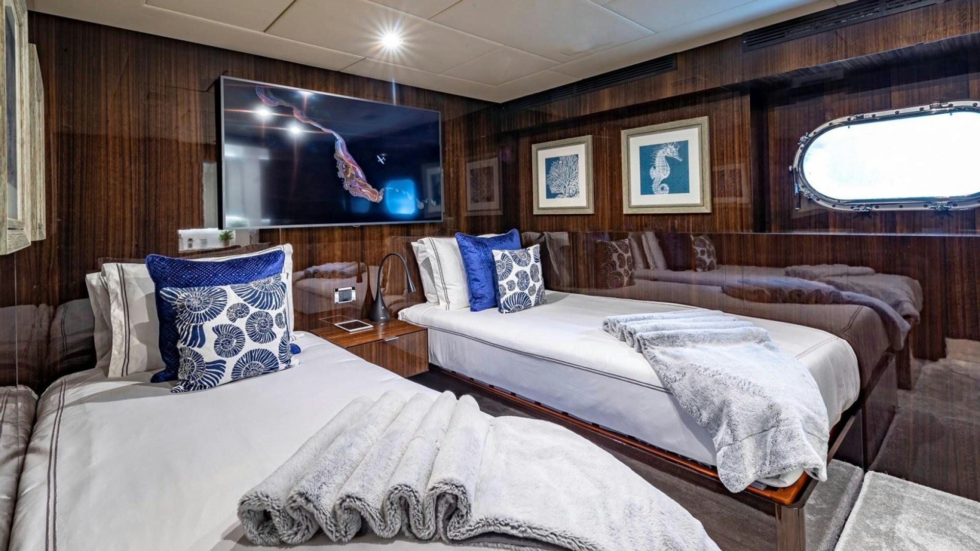 a room with two beds aboard OCULUS Yacht for Sale