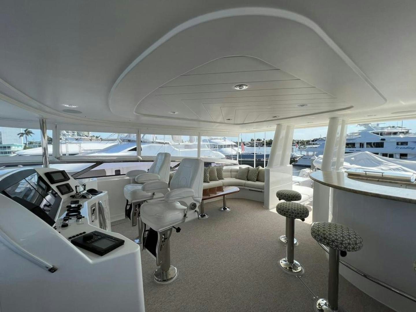 a room with a view of the water and boats aboard YES Yacht for Sale