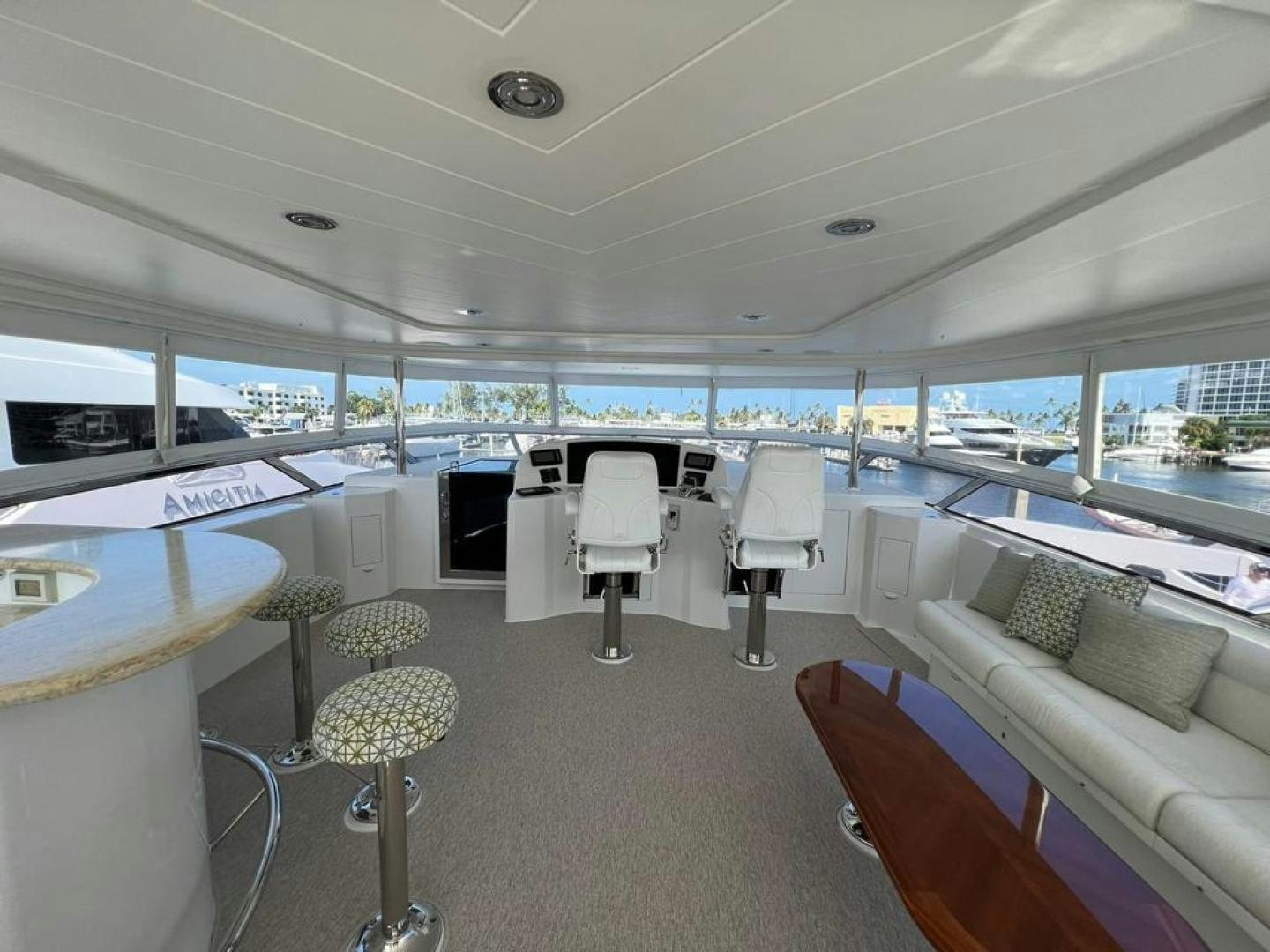a room with a couch and a table and chairs aboard YES Yacht for Sale