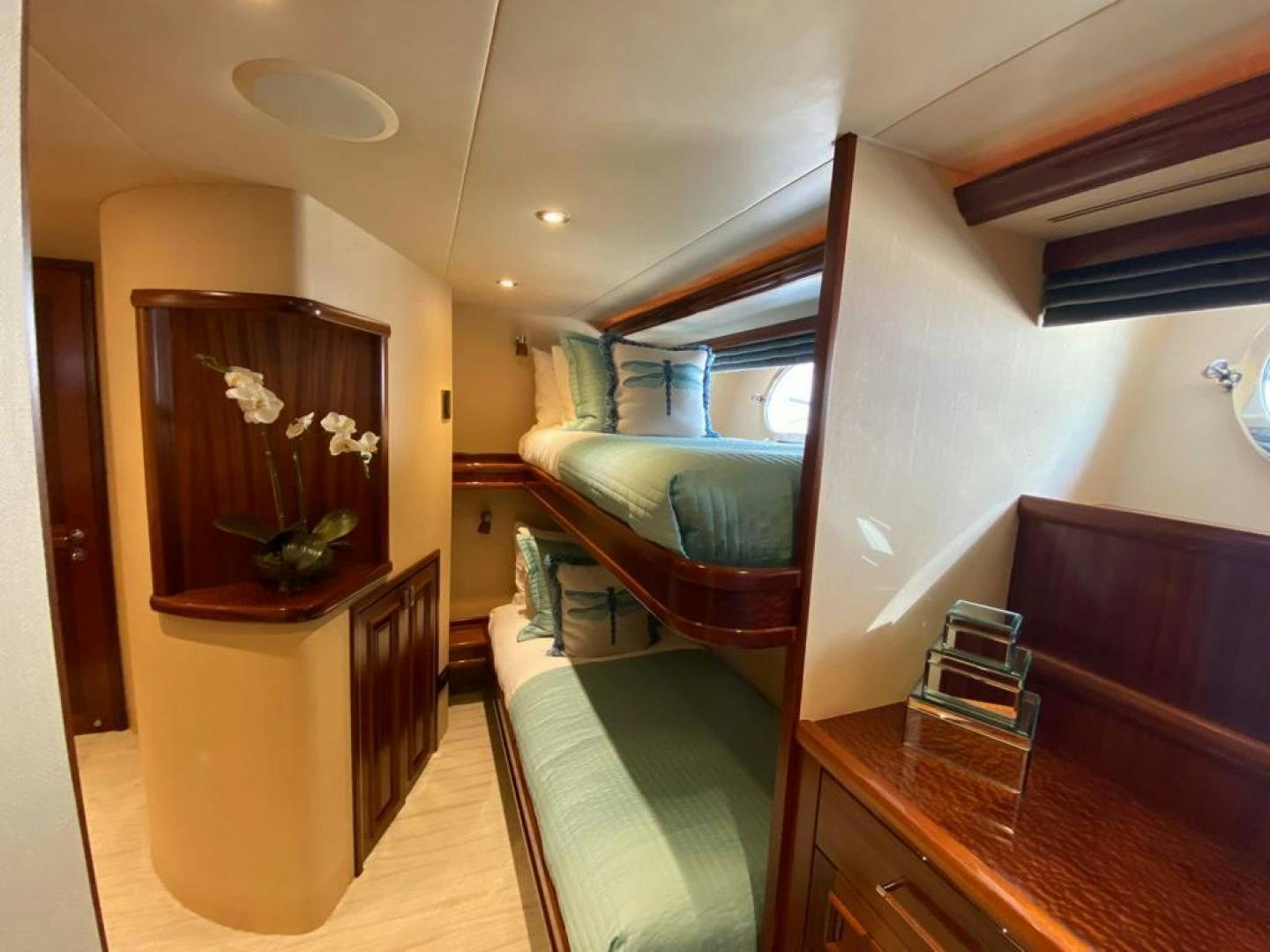 a room with a bed and a mirror aboard YES Yacht for Sale
