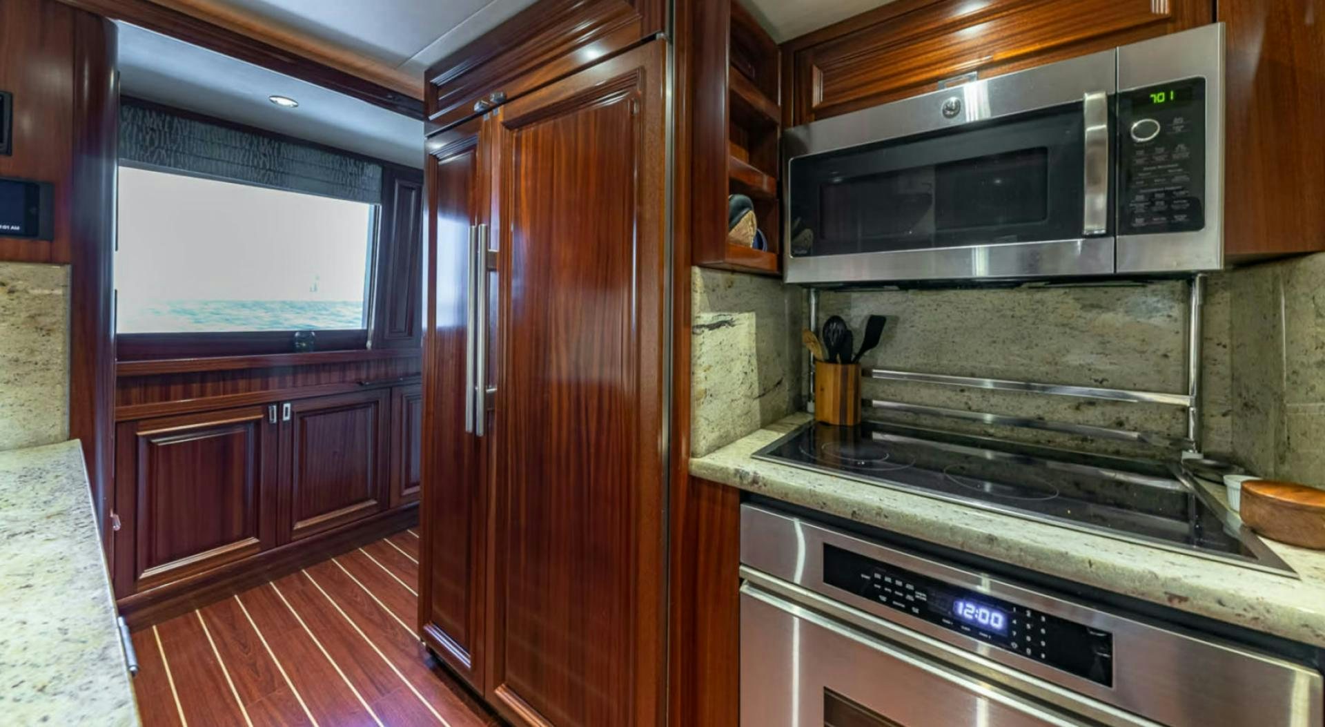 a kitchen with wooden cabinets aboard YES Yacht for Sale
