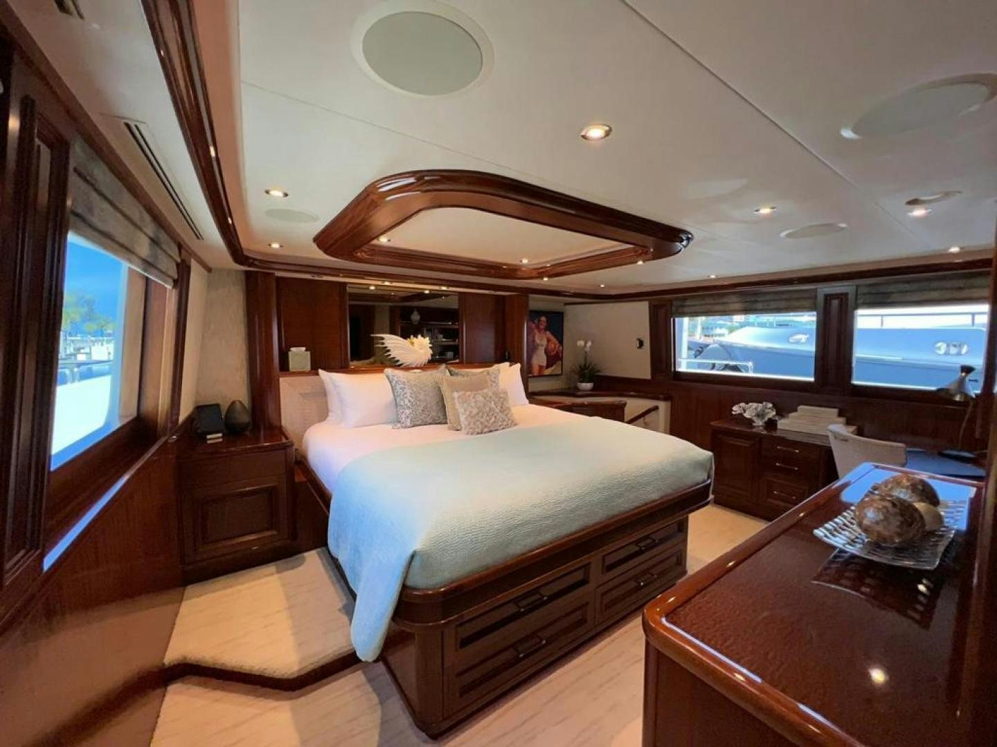 a bedroom with a bed and a table aboard YES Yacht for Sale