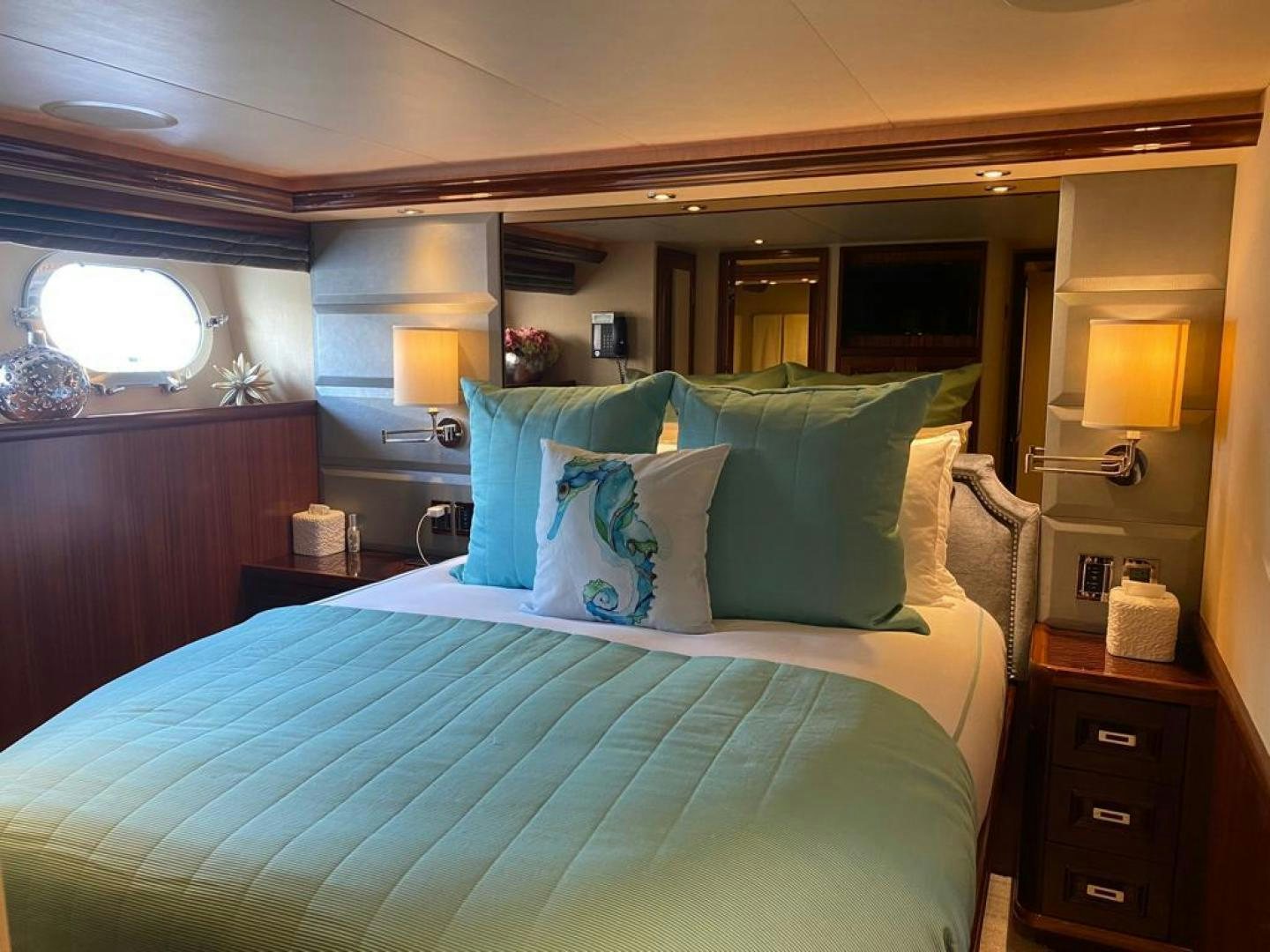 a bed with blue sheets aboard YES Yacht for Sale