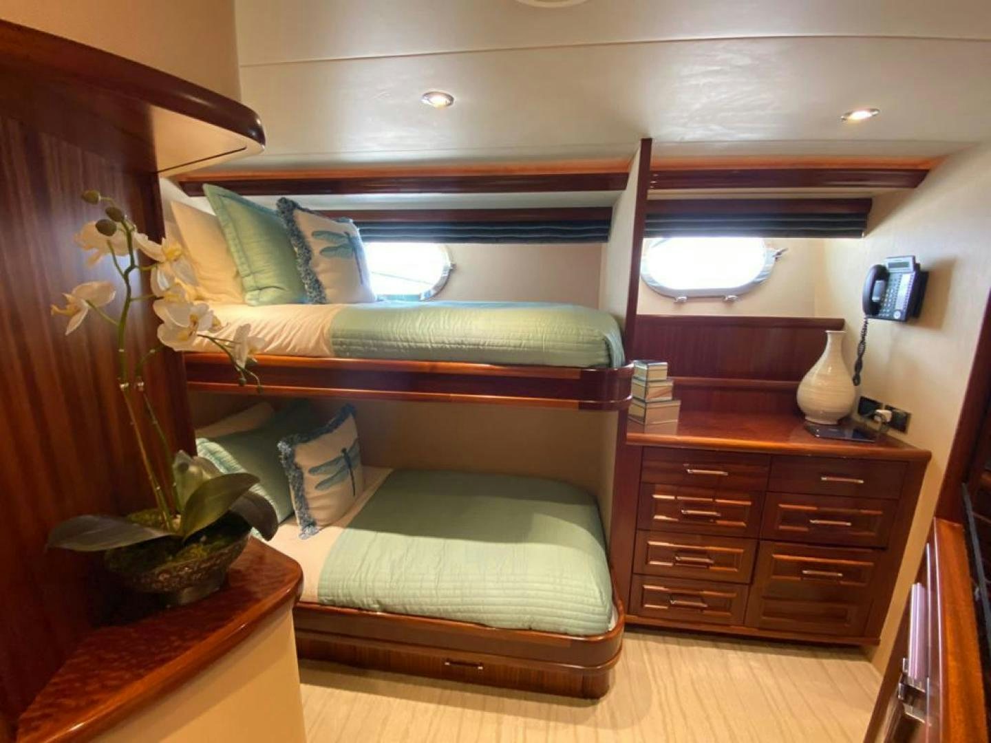 a bed with a wood frame aboard YES Yacht for Sale