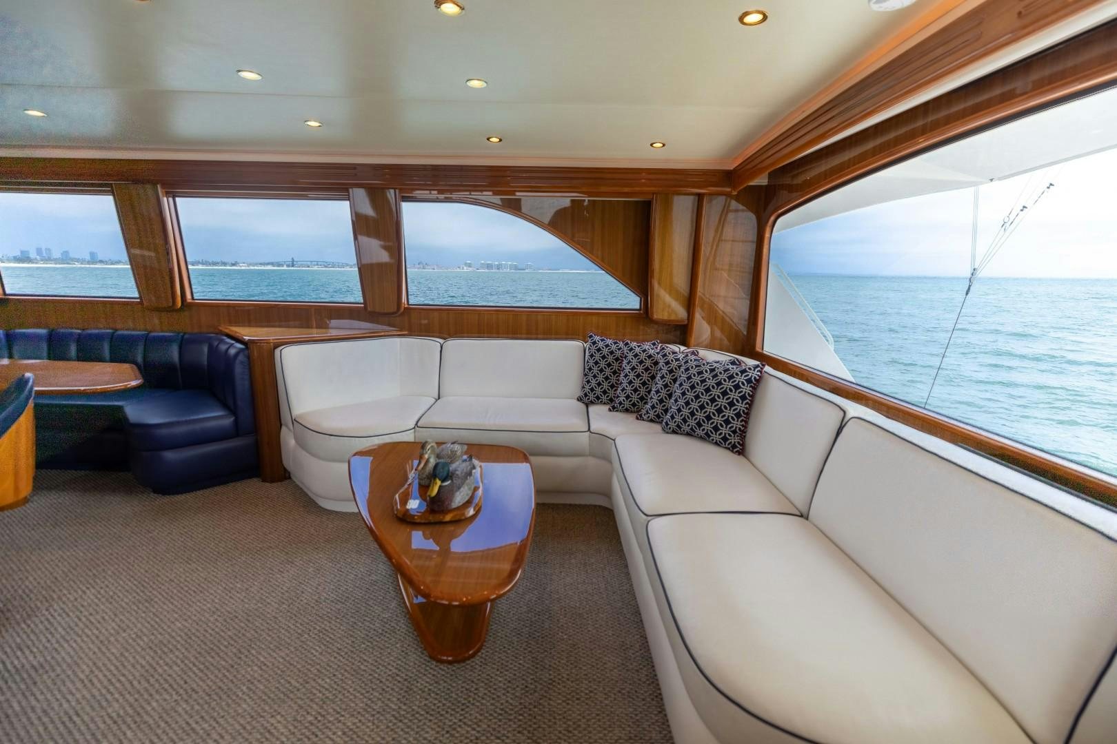 a living room with a couch and a table aboard KICKBACK Yacht for Sale