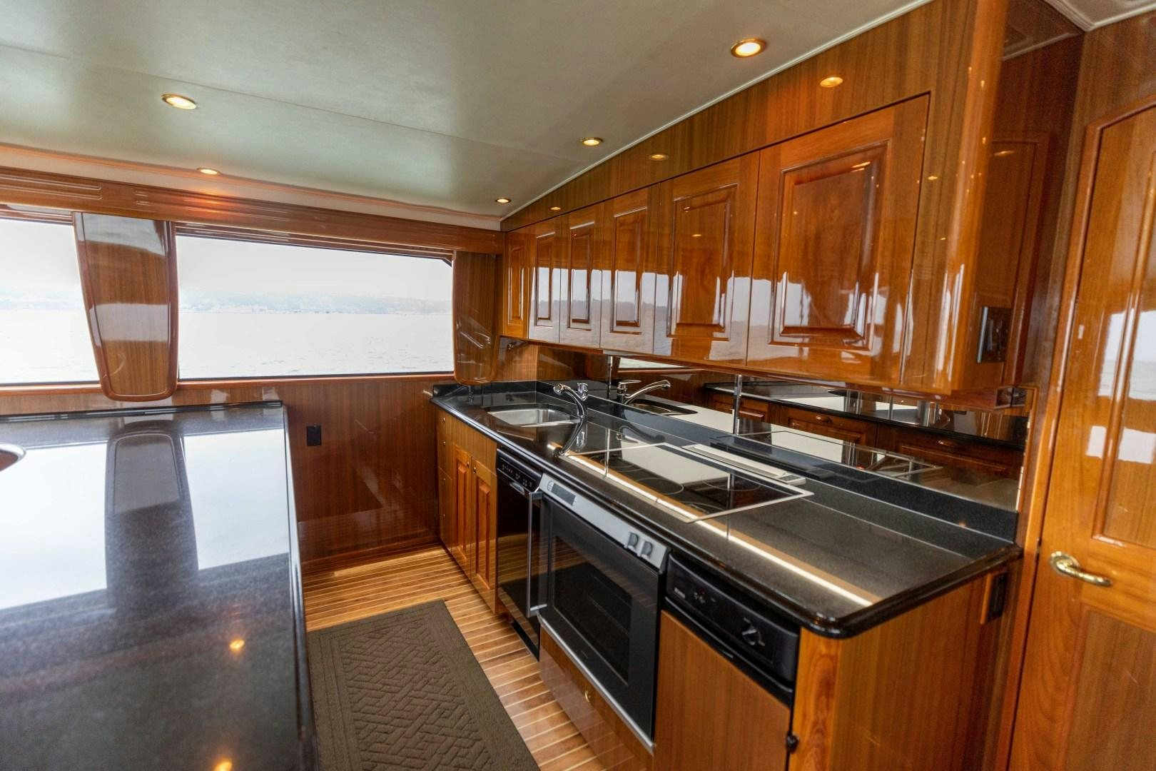 a kitchen with wooden cabinets aboard KICKBACK Yacht for Sale