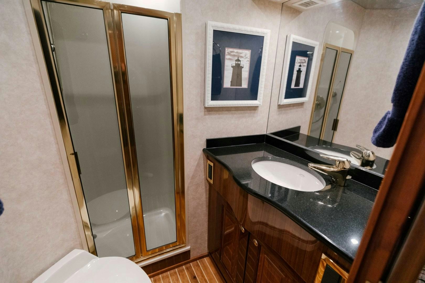 a bathroom with a sink and a mirror aboard KICKBACK Yacht for Sale