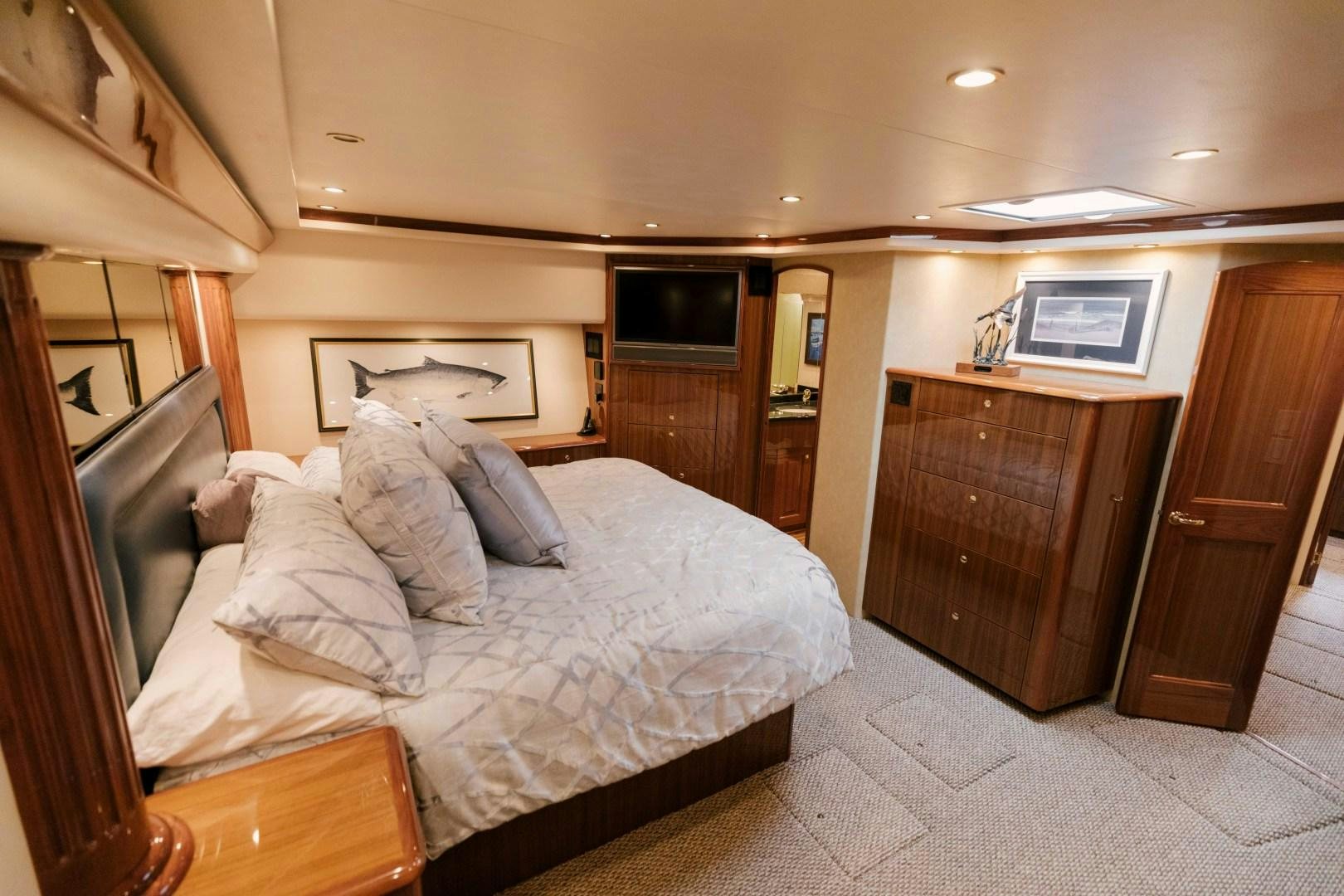 a bedroom with a bed and a television aboard KICKBACK Yacht for Sale