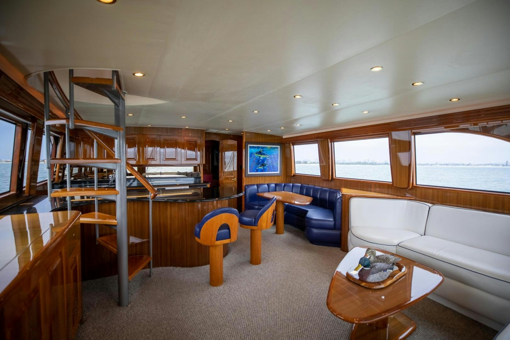 a living room with a staircase and a glass door aboard KICKBACK Yacht for Sale