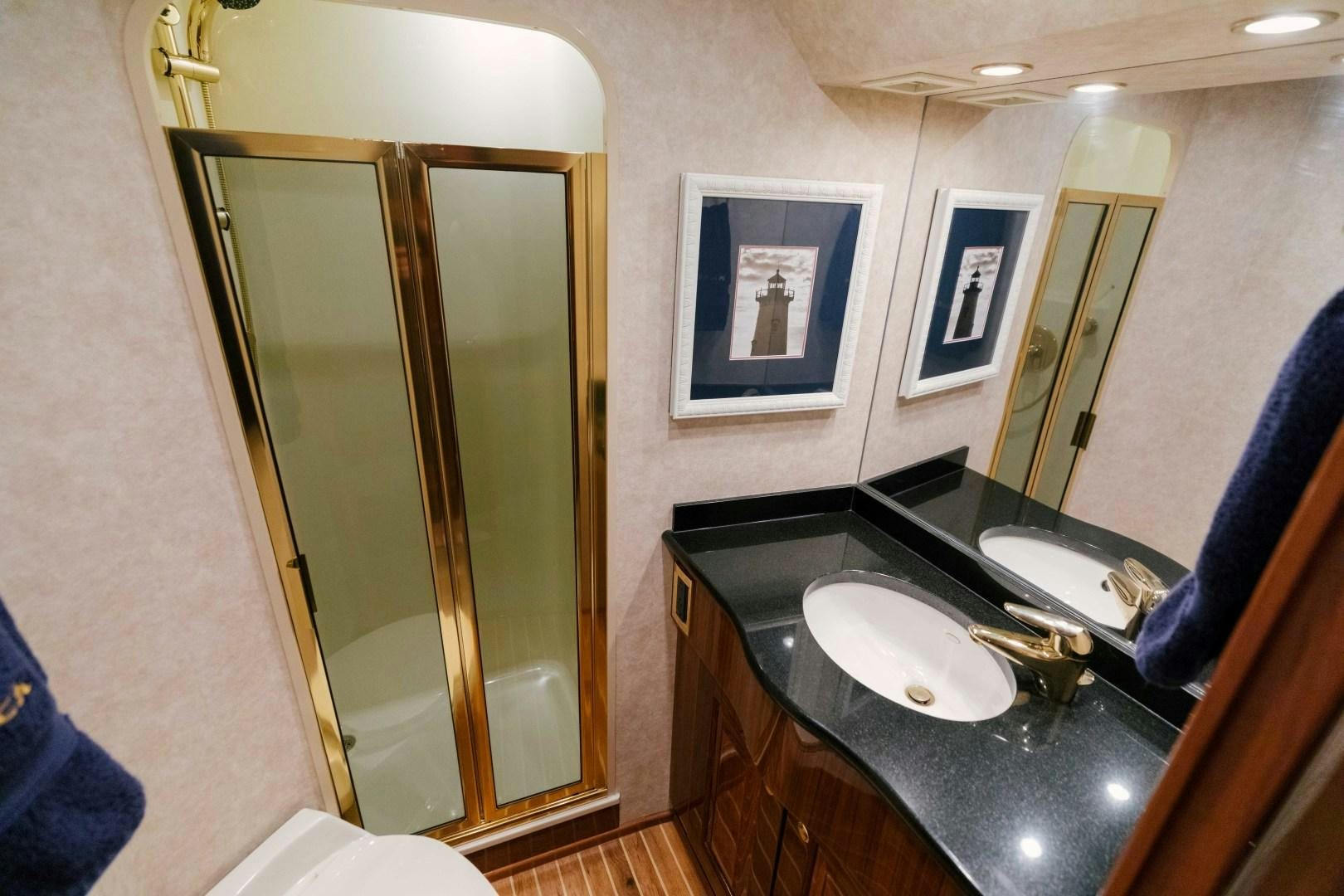 a bathroom with a sink and a mirror aboard KICKBACK Yacht for Sale