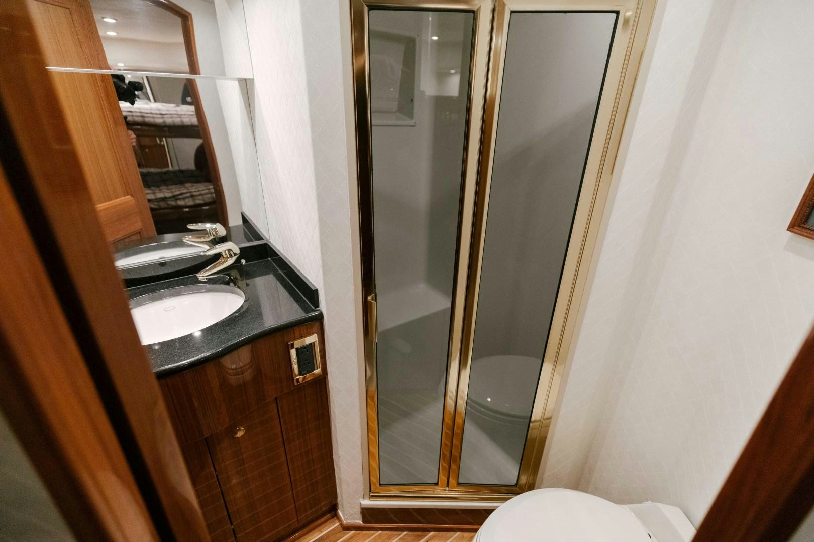 a bathroom with a glass shower aboard KICKBACK Yacht for Sale