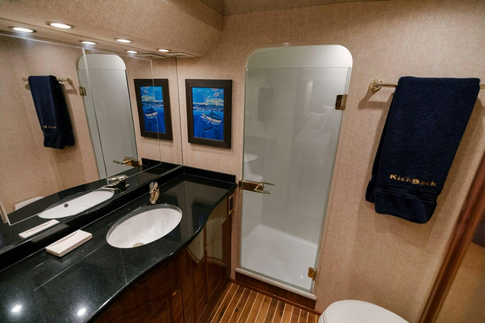 a bathroom with a sink and a mirror aboard KICKBACK Yacht for Sale