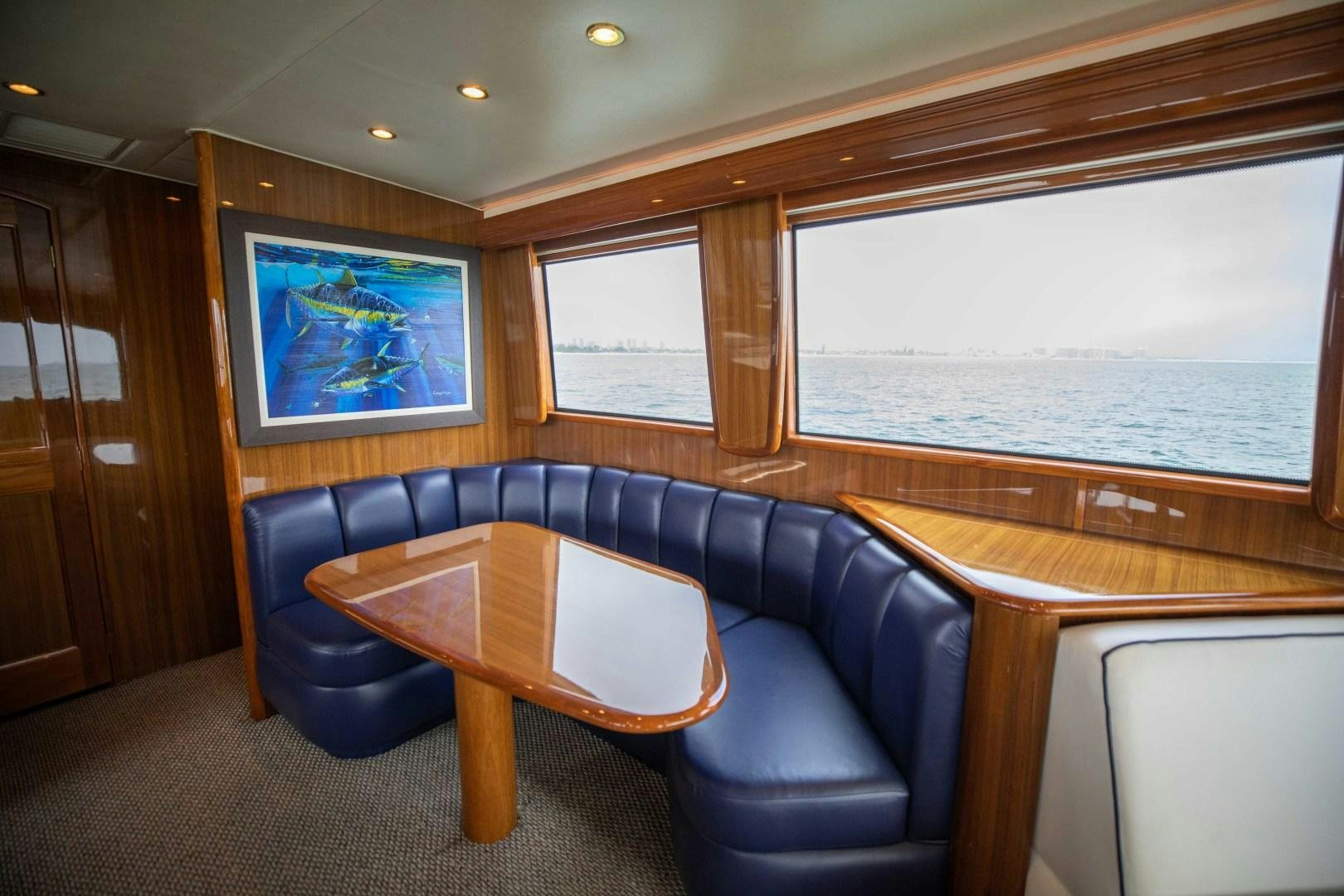 a room with a table and chairs aboard KICKBACK Yacht for Sale