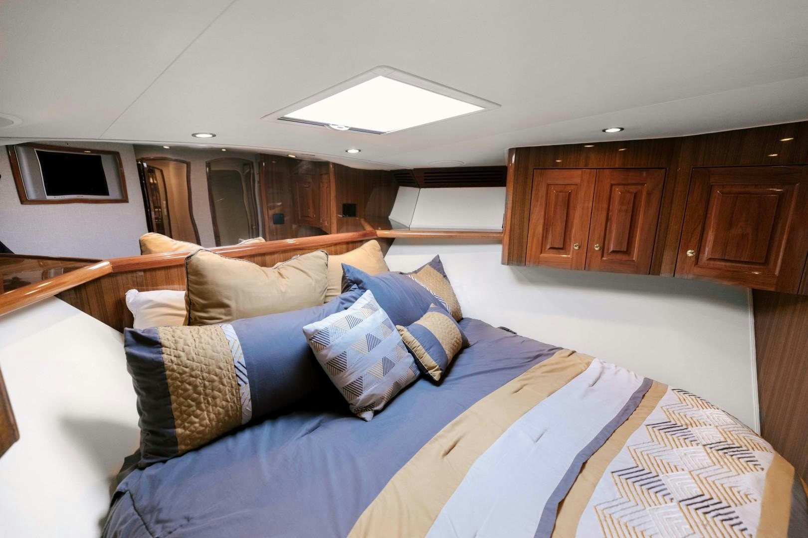 a bedroom with a bed and a television aboard KICKBACK Yacht for Sale