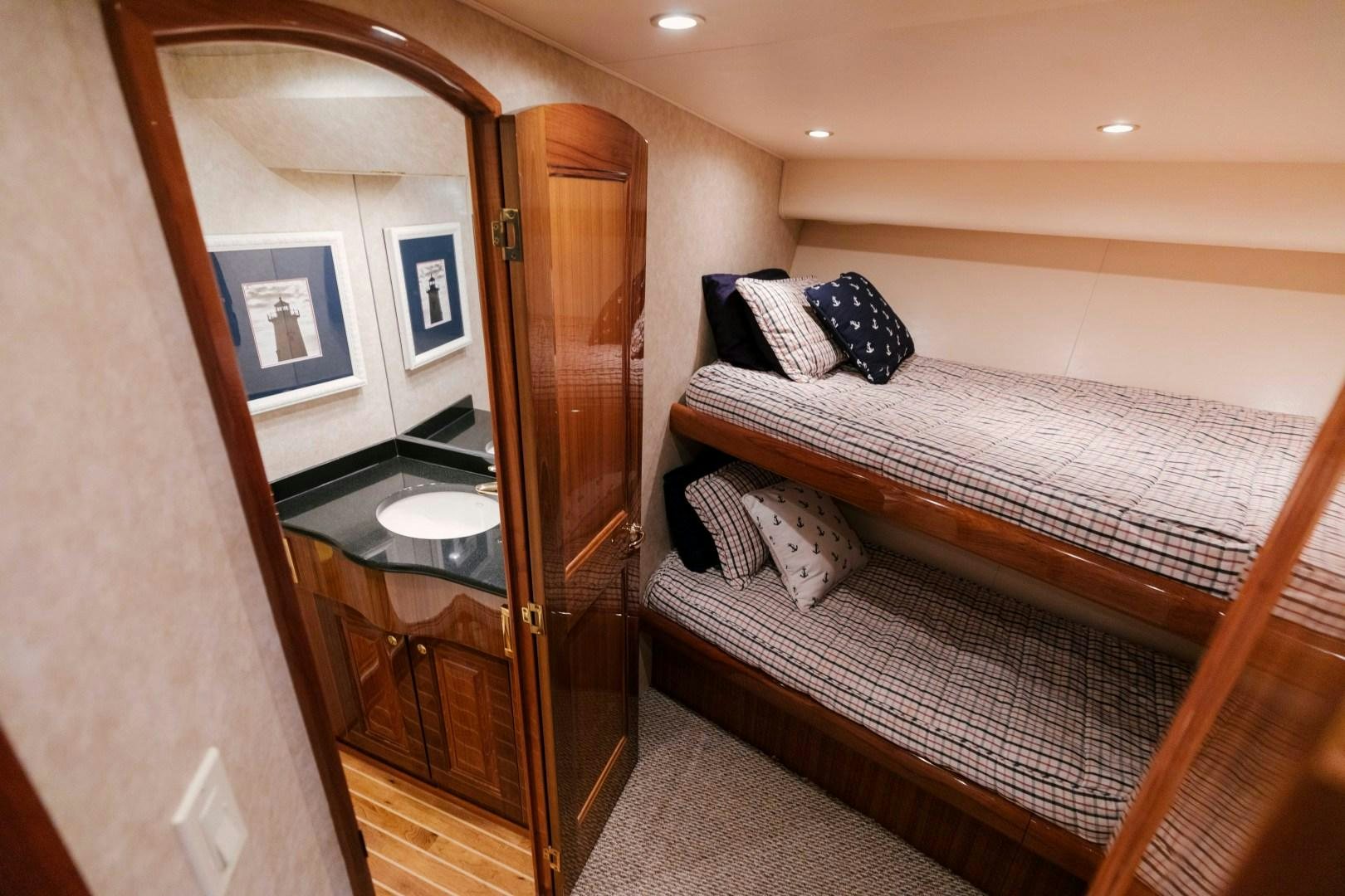 a bedroom with a double bed aboard KICKBACK Yacht for Sale