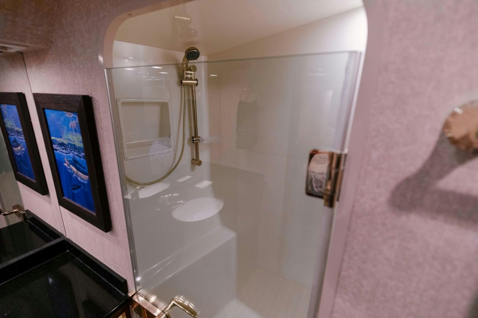 a bathroom with a shower and a mirror aboard KICKBACK Yacht for Sale