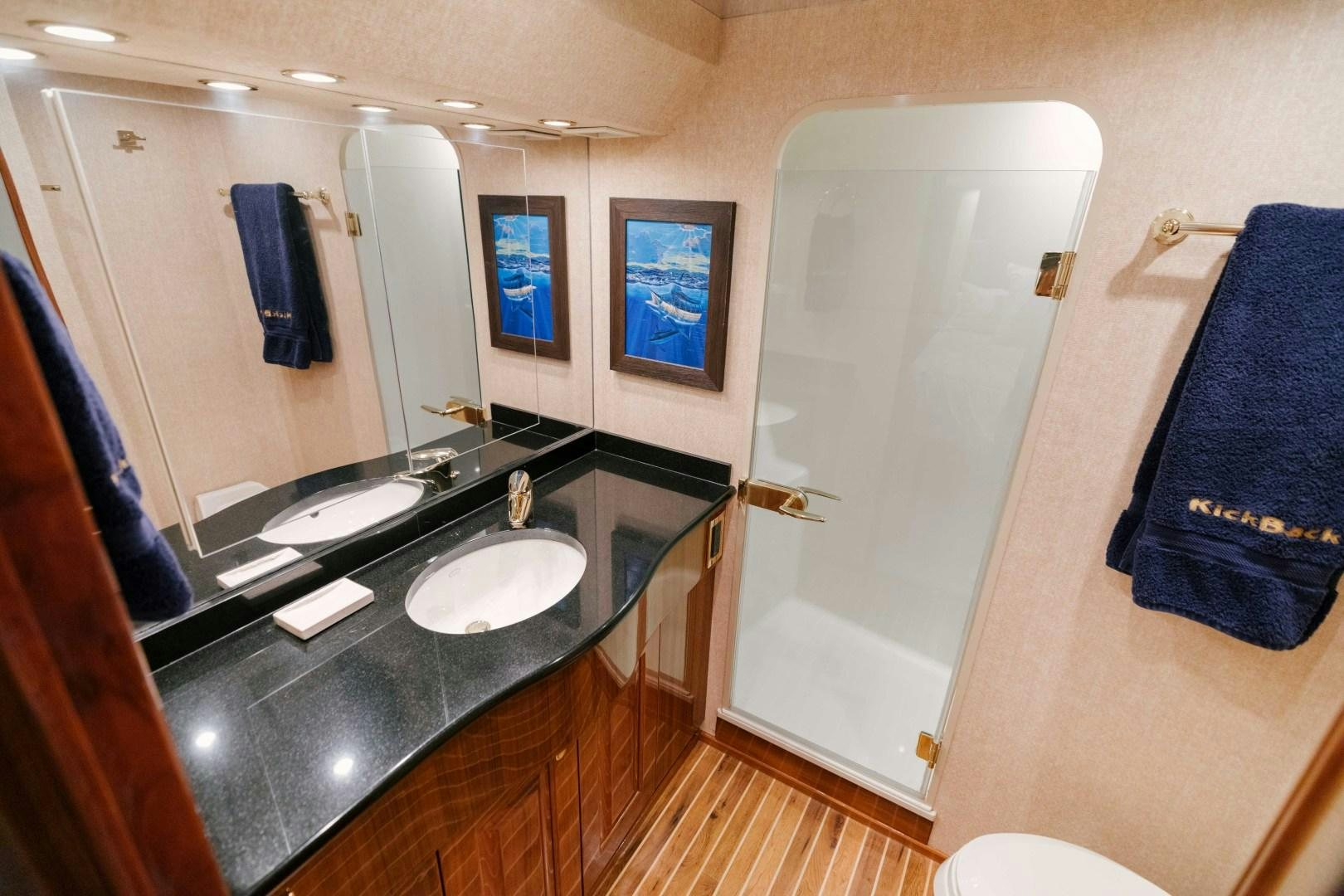 a bathroom with a sink and a mirror aboard KICKBACK Yacht for Sale