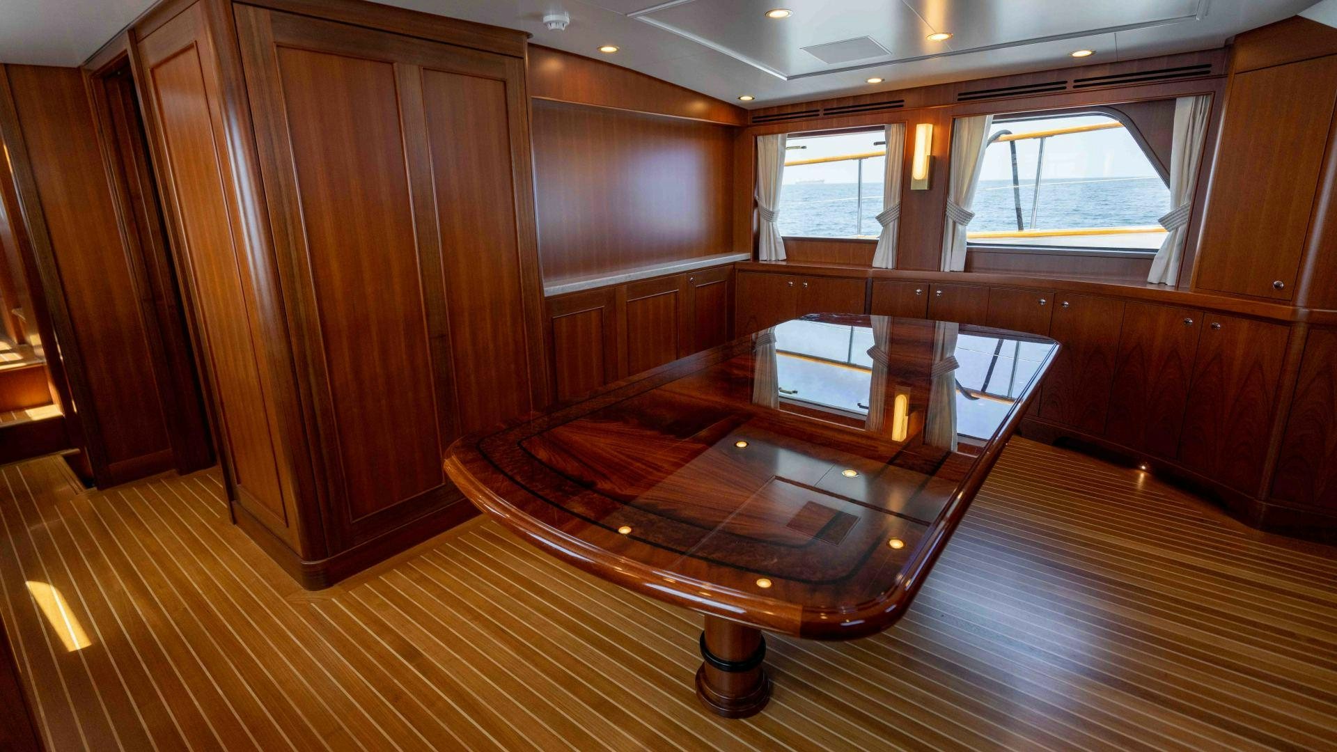 a room with a wood floor and a wood cabinet aboard NEREUS Yacht for Sale