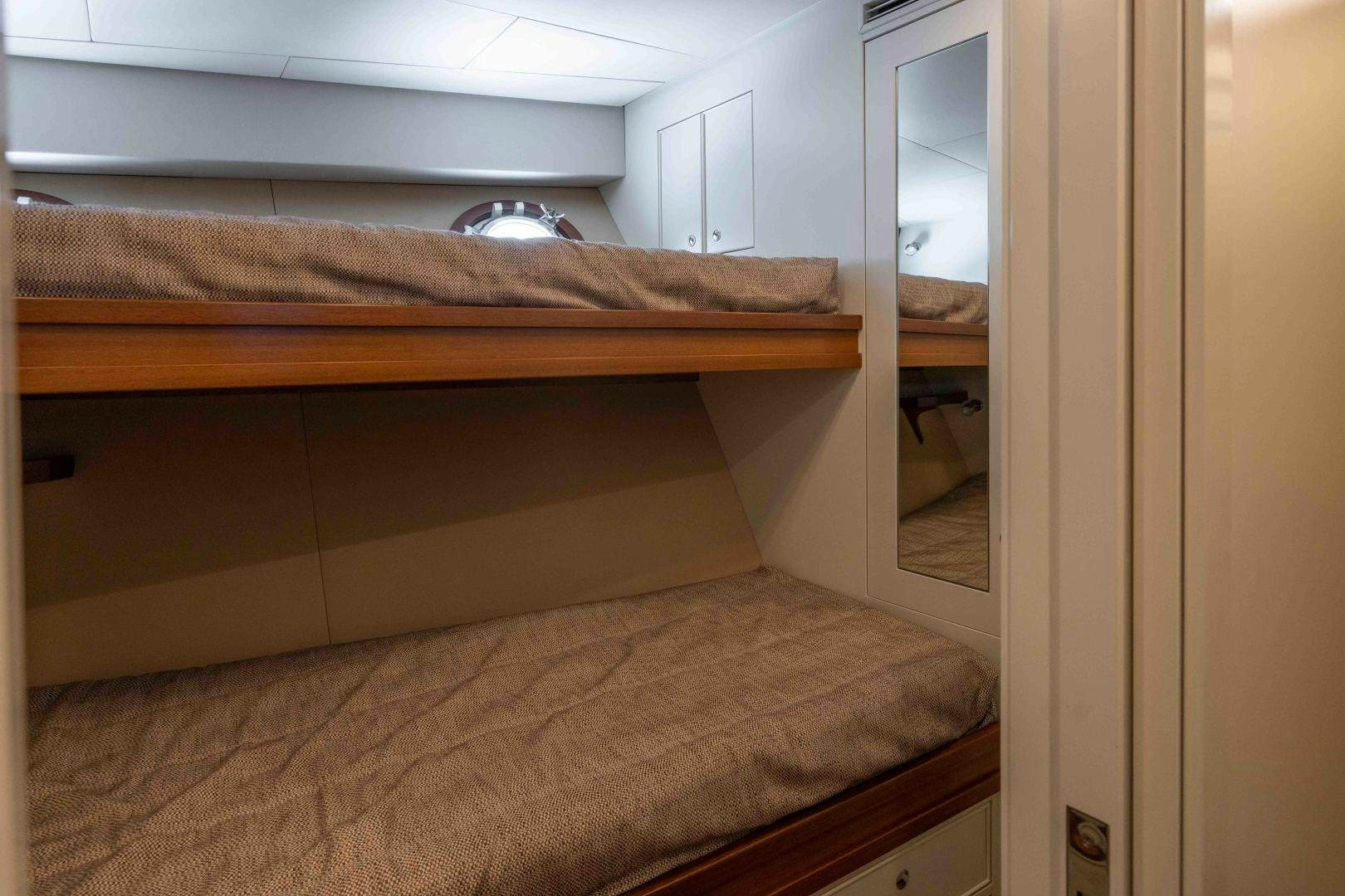 a room with a bed and a closet aboard NEREUS Yacht for Sale