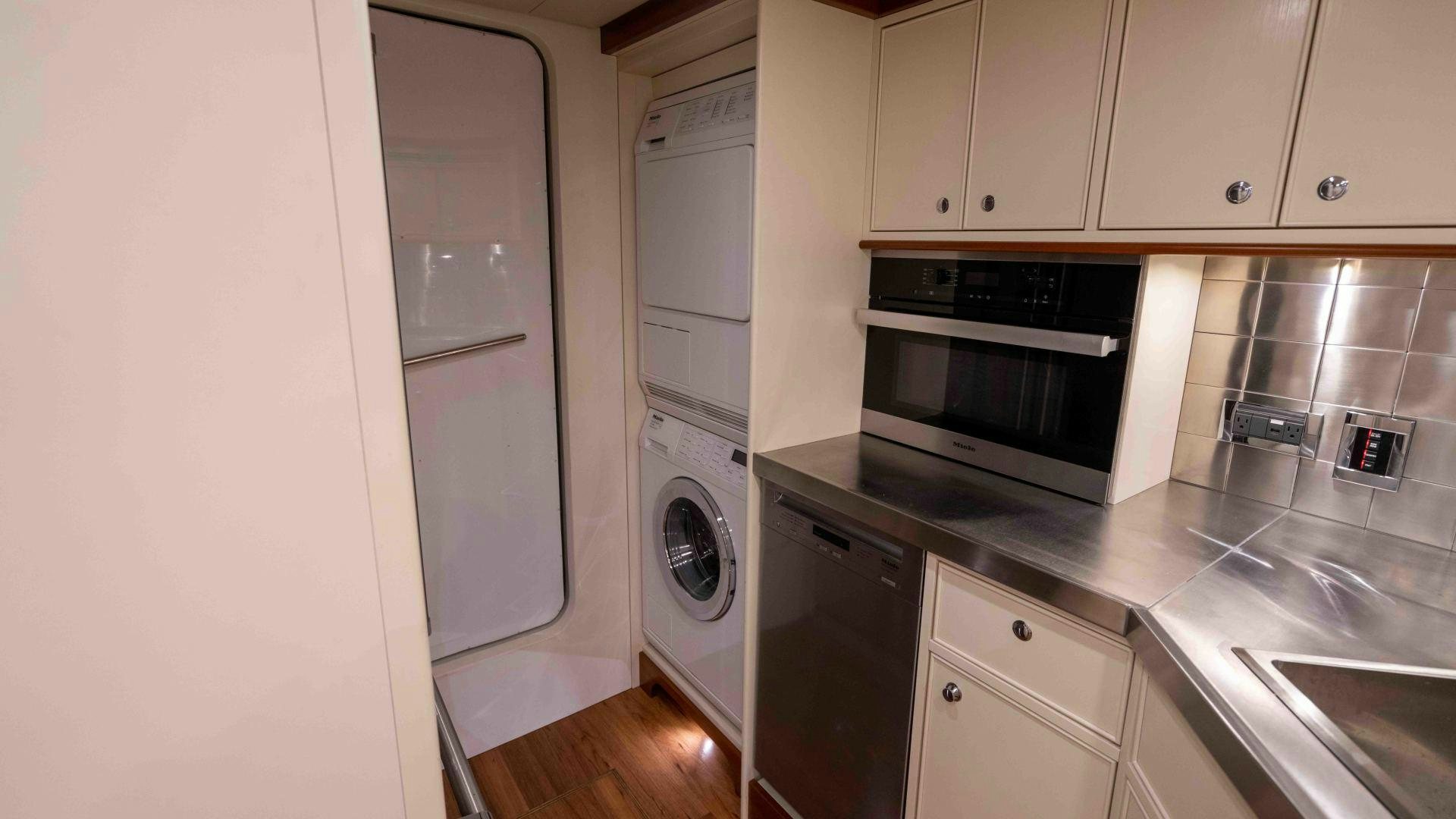 a kitchen with white cabinets aboard NEREUS Yacht for Sale