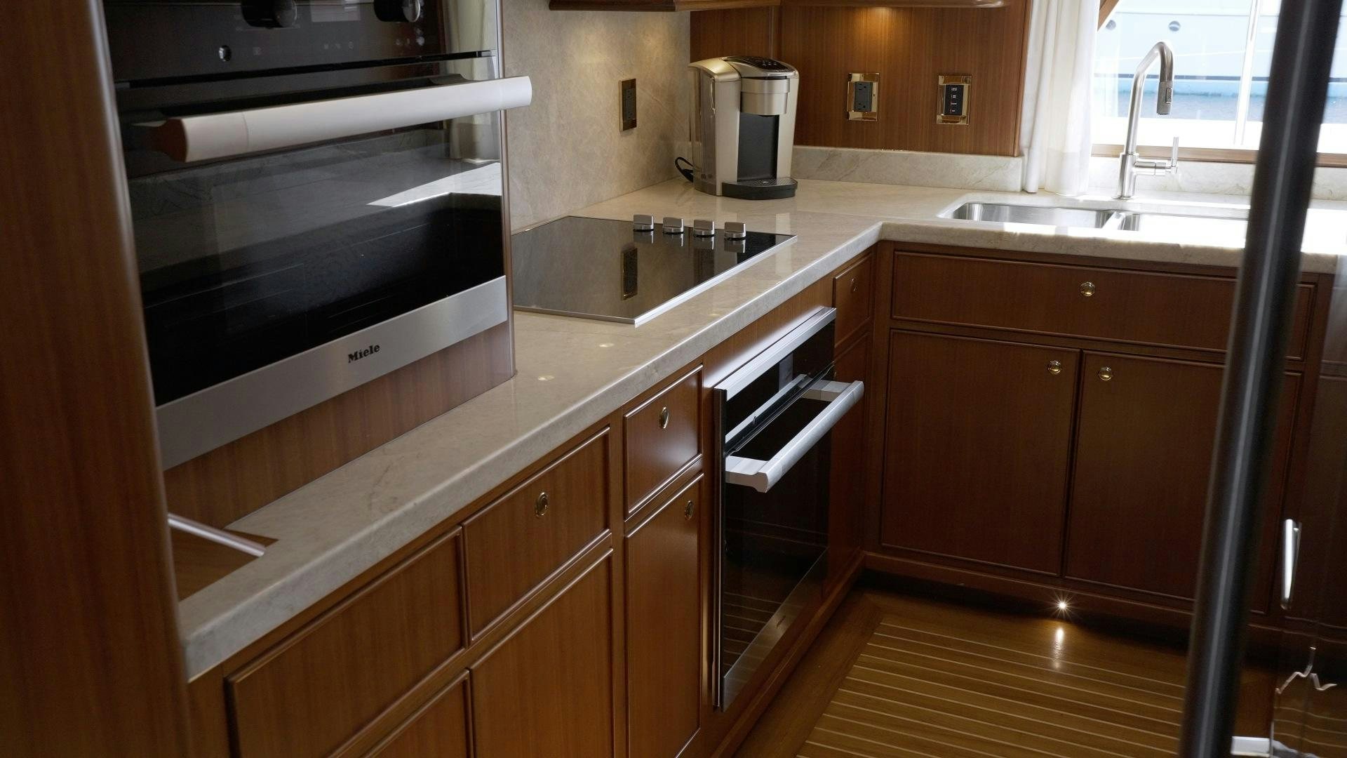 a kitchen with stainless steel appliances aboard NEREUS Yacht for Sale