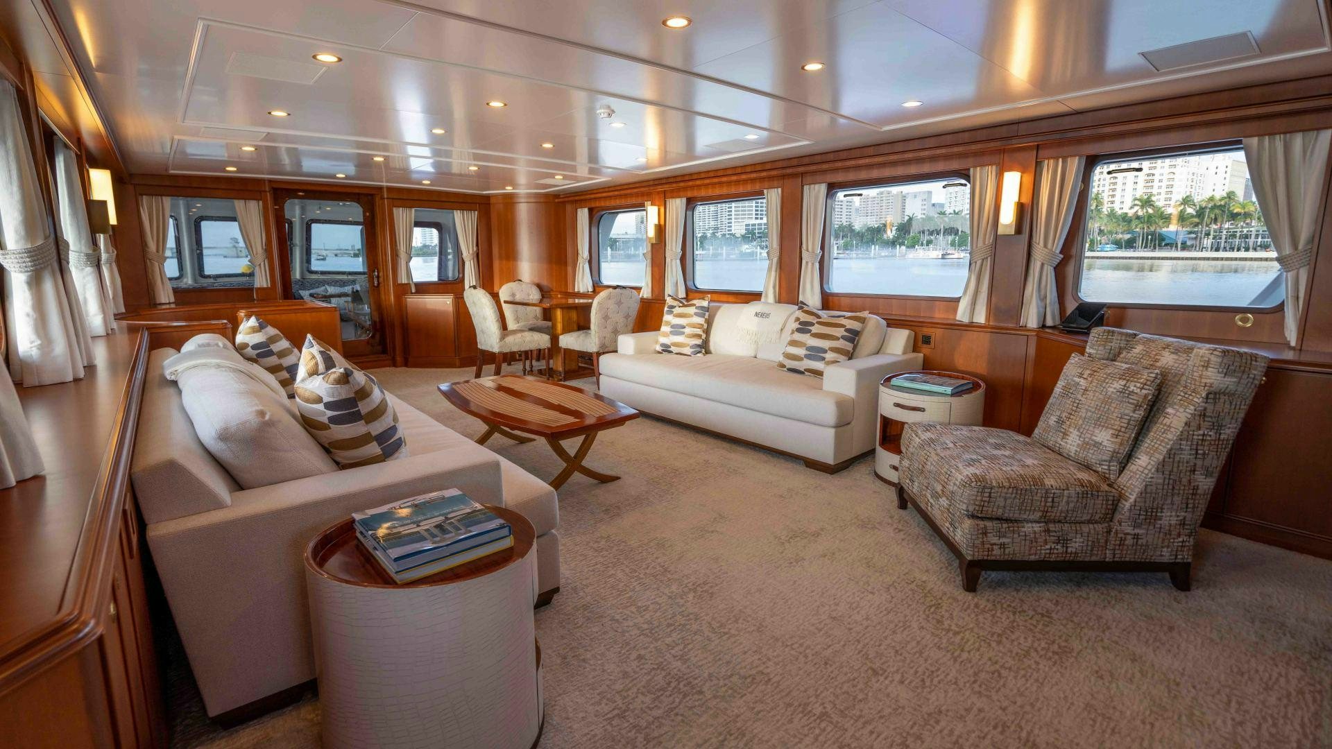 a living room with a couch and a table aboard NEREUS Yacht for Sale
