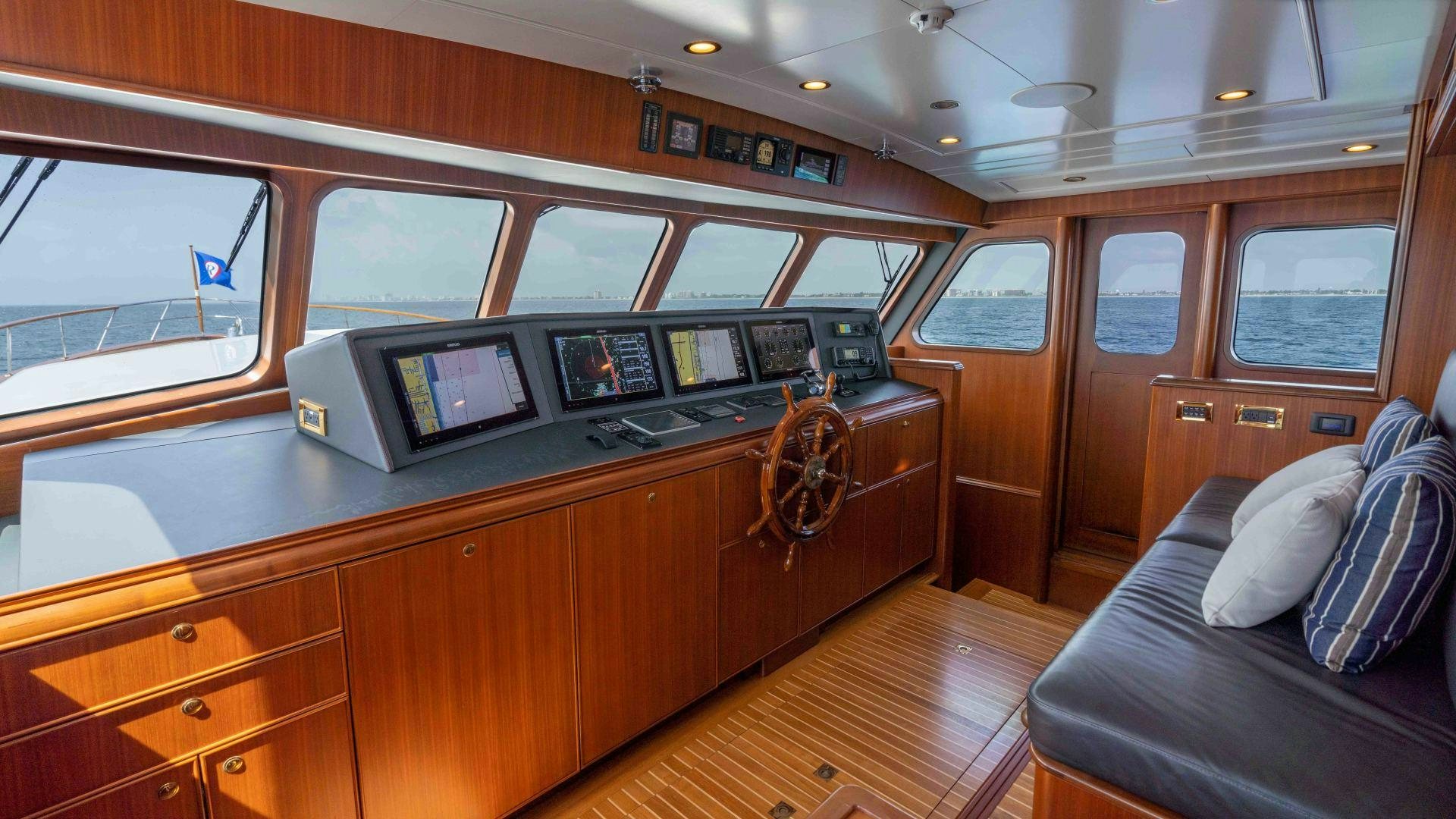 a room with a couch and a tv on the counter aboard NEREUS Yacht for Sale