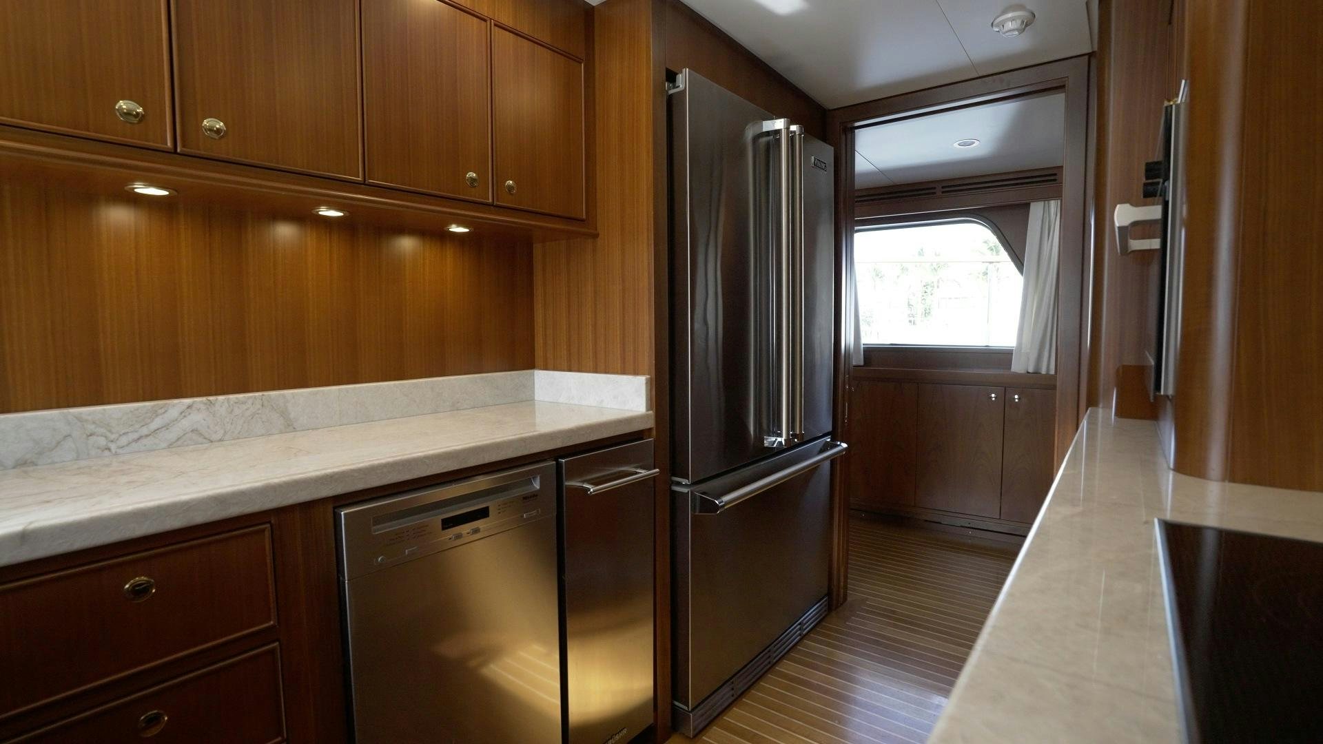 a kitchen with a stainless steel refrigerator aboard NEREUS Yacht for Sale