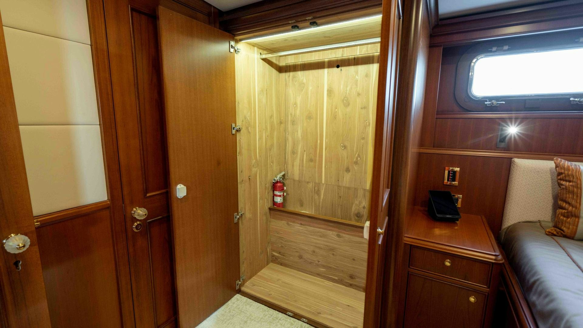 a room with a bed and a wood door aboard NEREUS Yacht for Sale