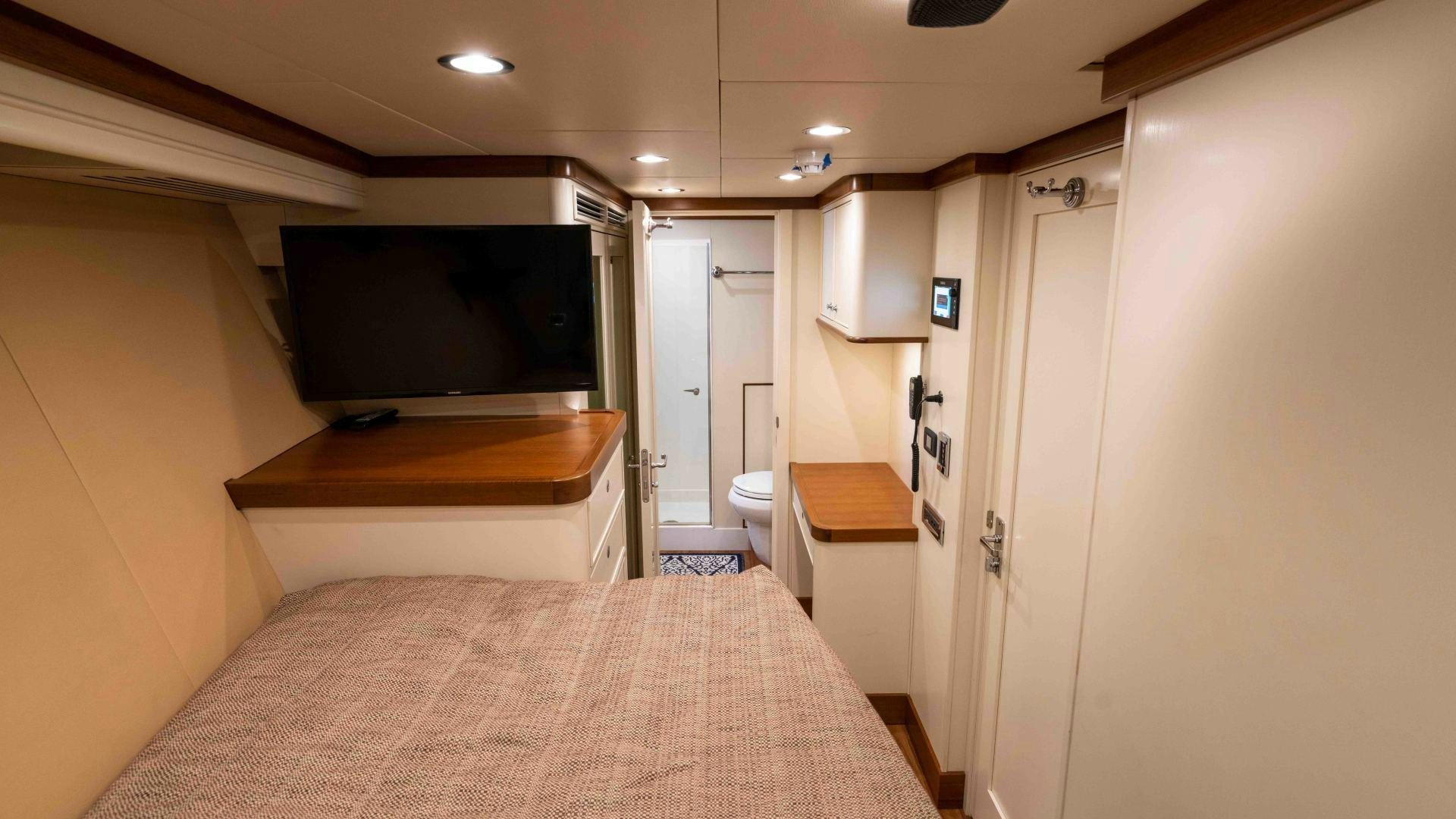 a bedroom with a large tv aboard NEREUS Yacht for Sale