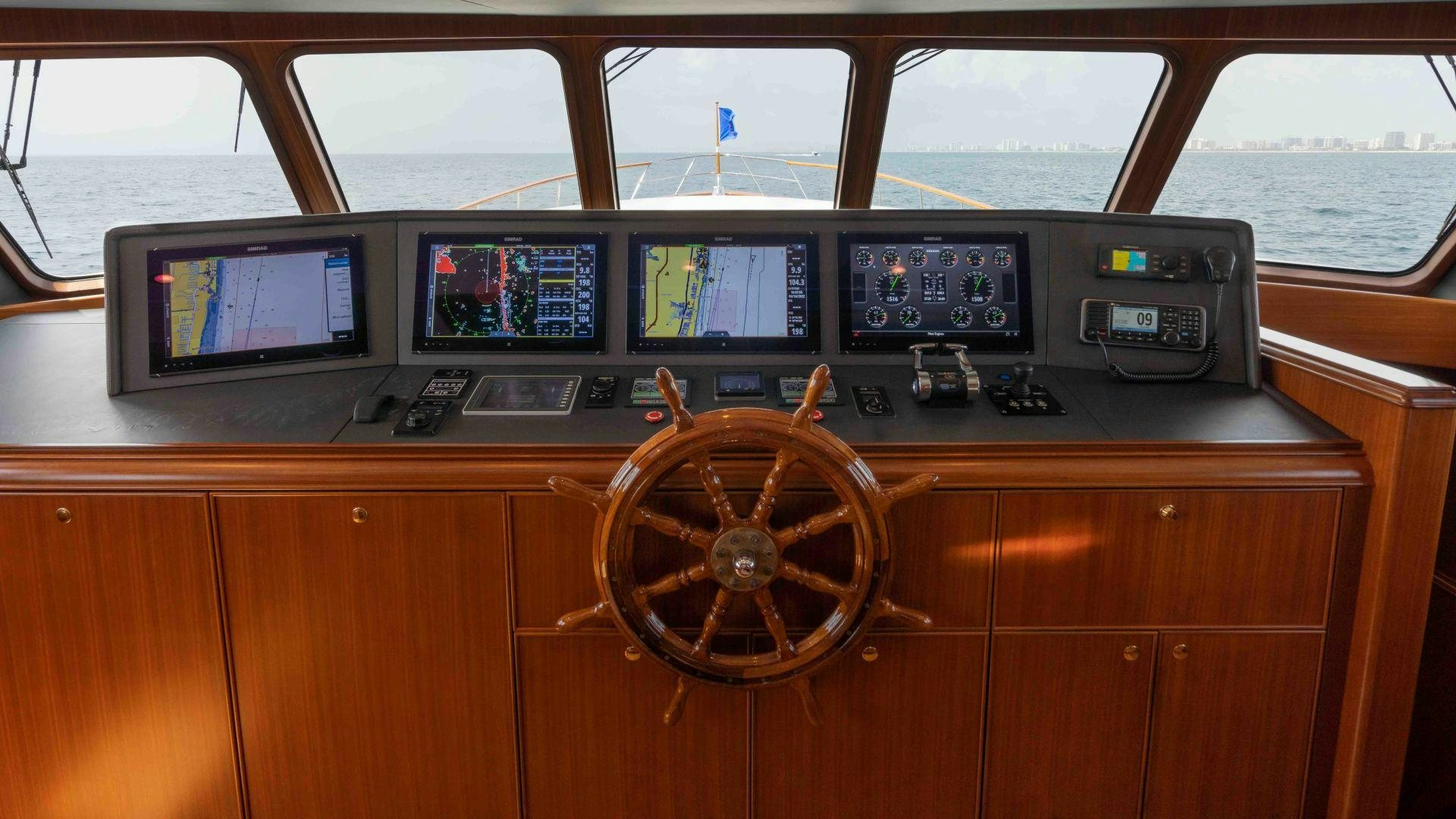 a control panel on a wooden cabinet aboard NEREUS Yacht for Sale