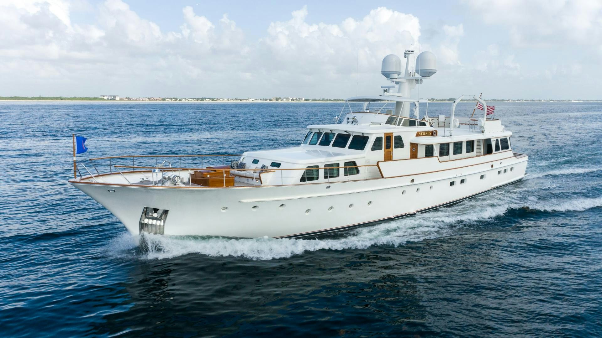 a white boat in the water aboard NEREUS Yacht for Sale