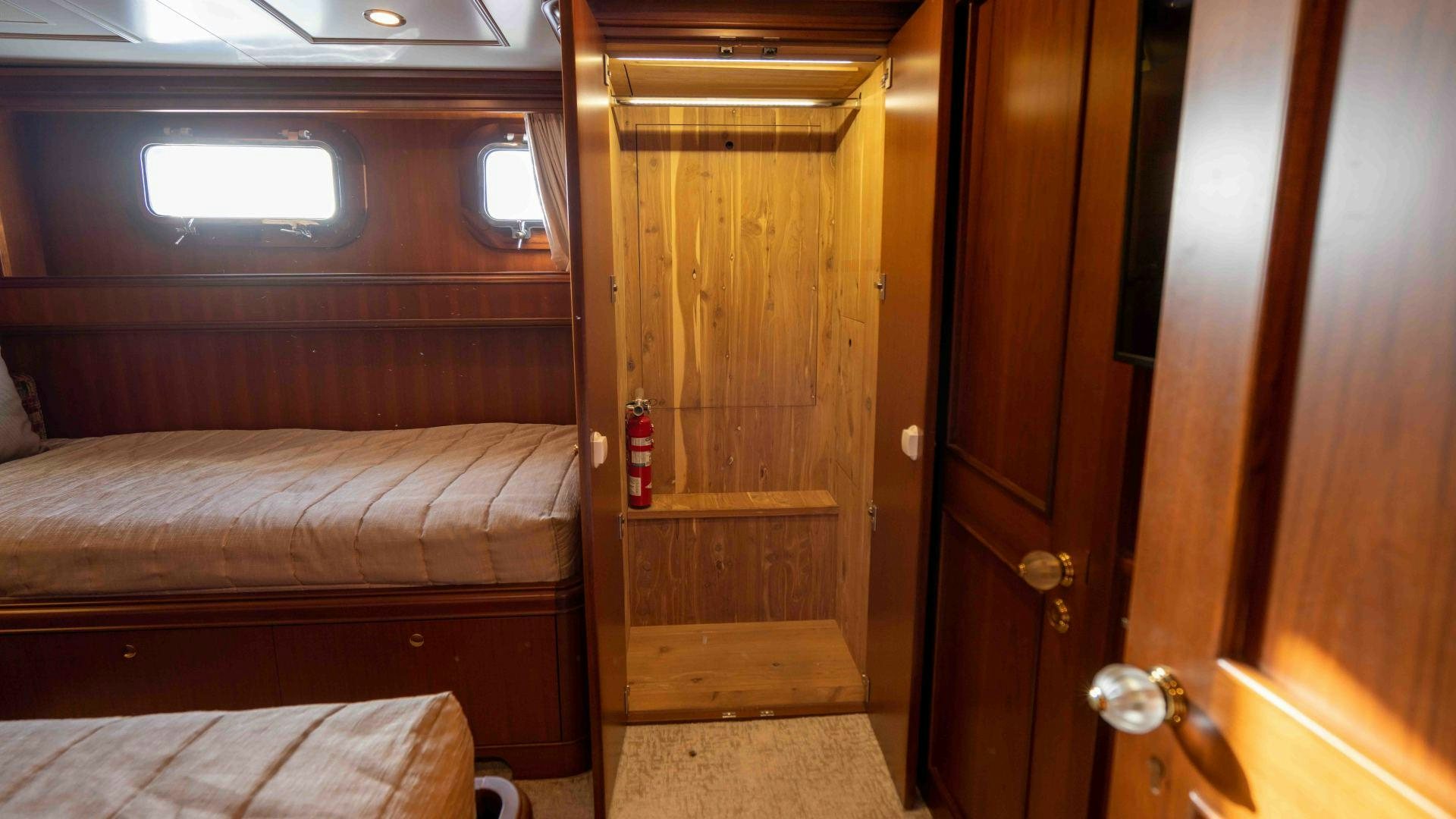 a room with a bed and a door aboard NEREUS Yacht for Sale
