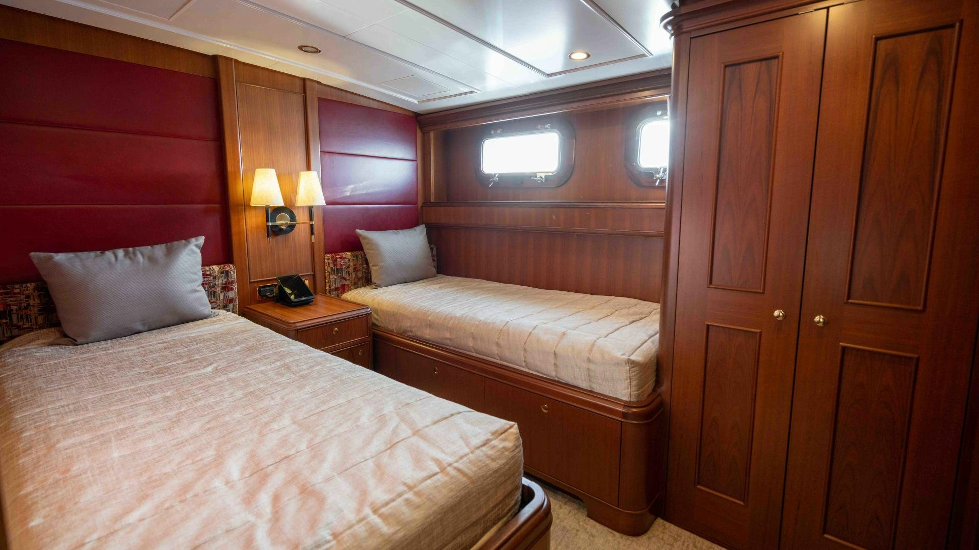 a room with two beds aboard NEREUS Yacht for Sale