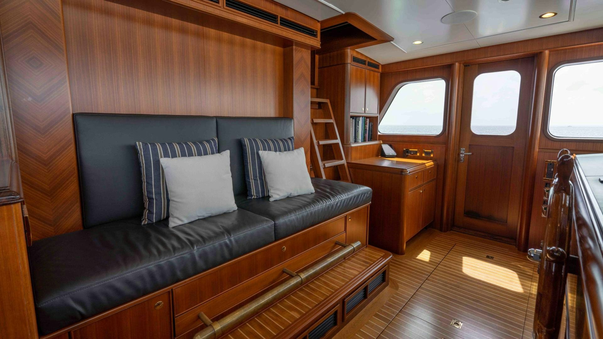a living room with a couch and a table aboard NEREUS Yacht for Sale
