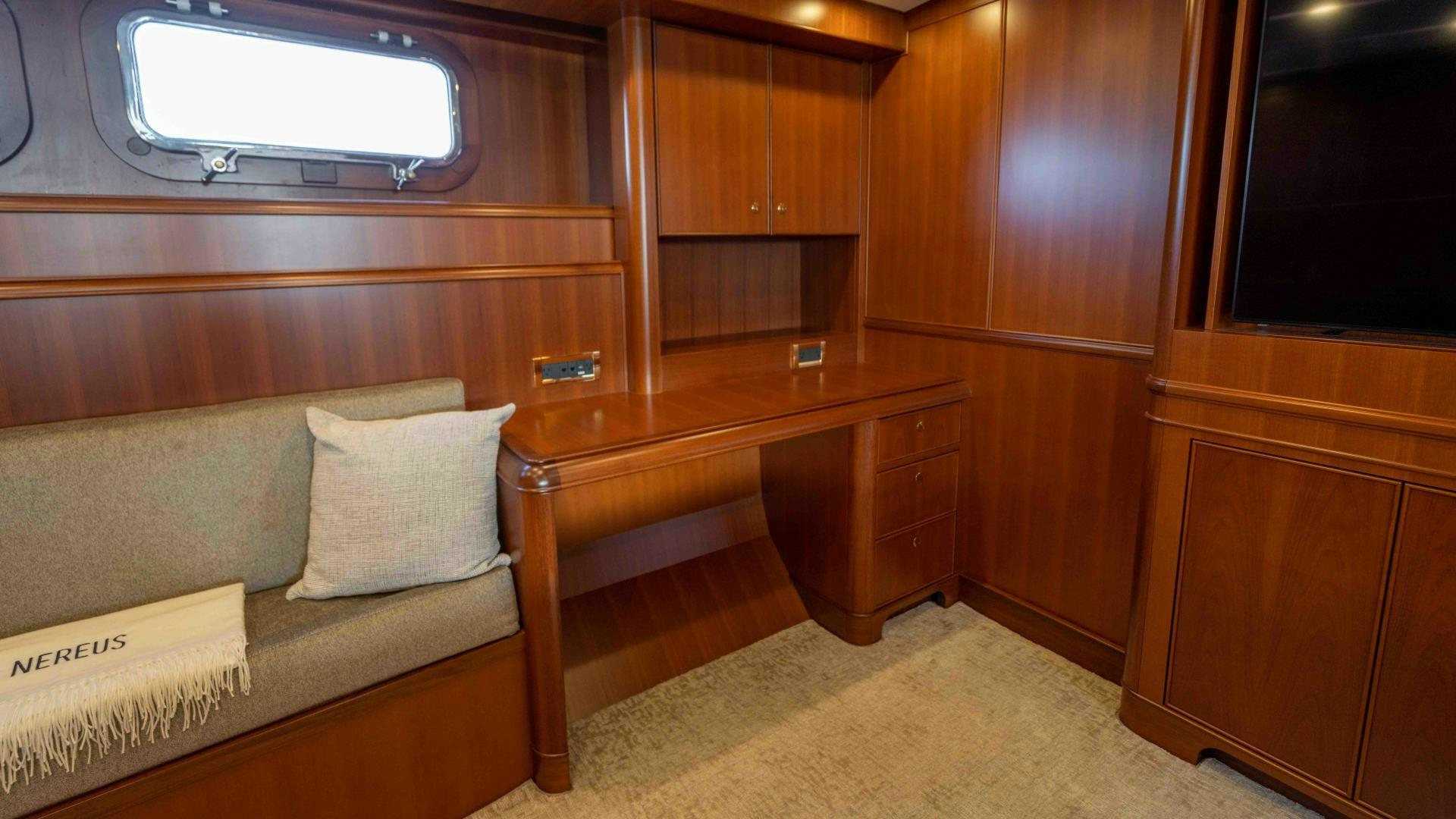 a room with a bed and a desk aboard NEREUS Yacht for Sale