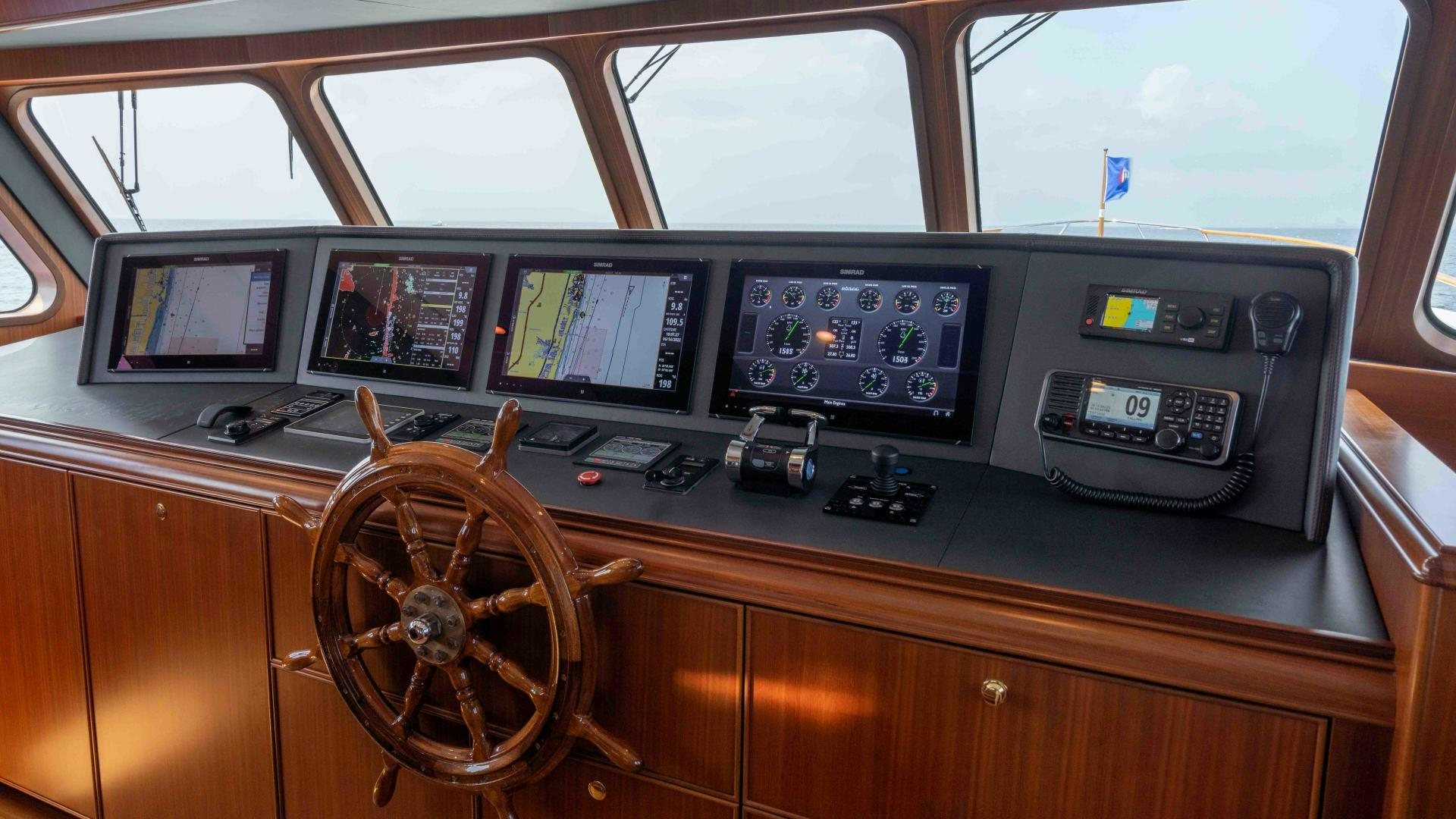 a wooden desk with computers and monitors aboard NEREUS Yacht for Sale