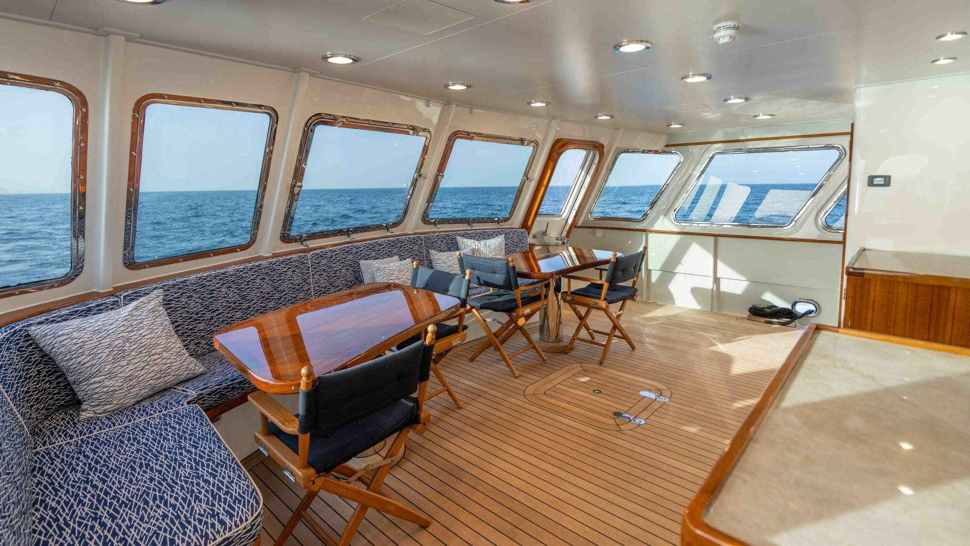 a room with a couch and chairs aboard NEREUS Yacht for Sale