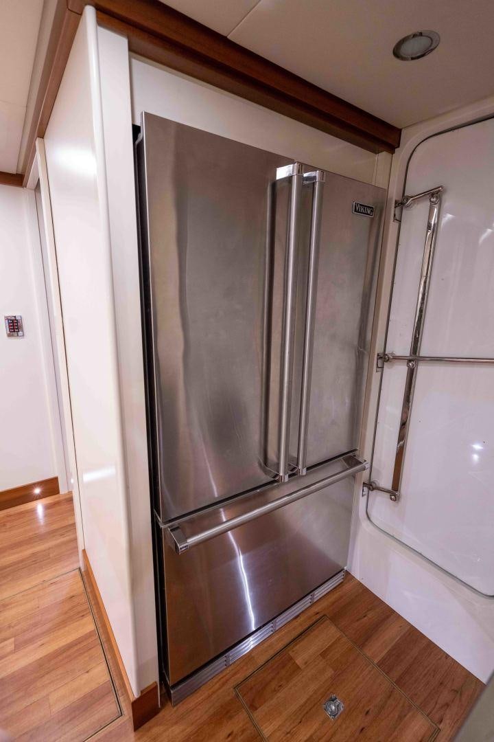 a stainless steel refrigerator in a kitchen aboard NEREUS Yacht for Sale